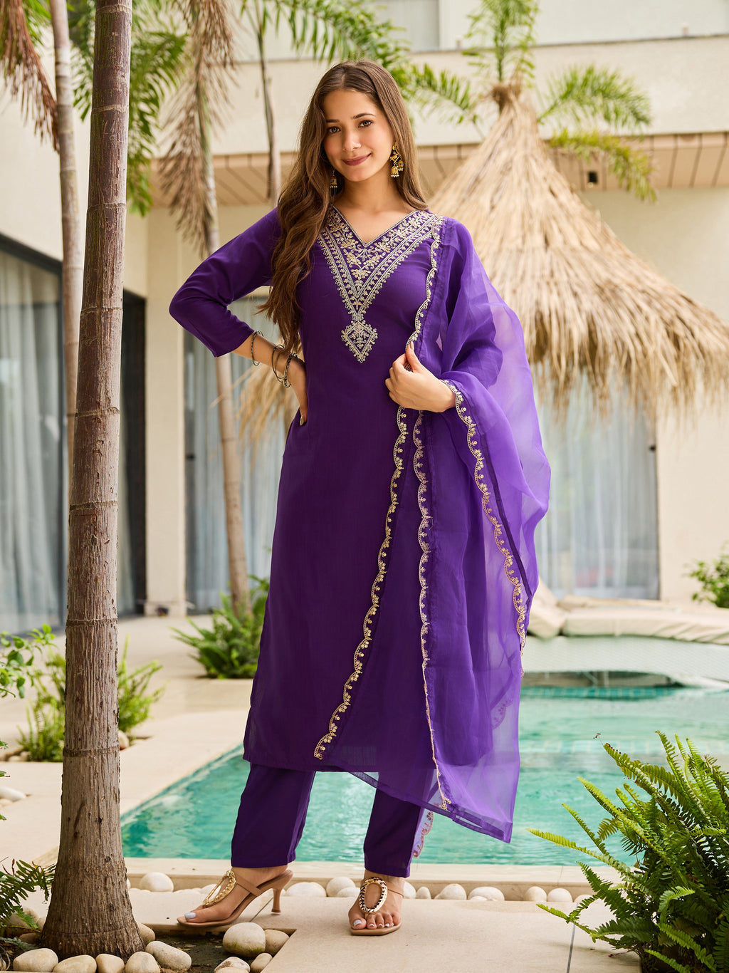 TRENDBUY model showcasing a violet rayon slub embroidered kurti with matching pants and organza dupatta, posing confidently by a poolside.