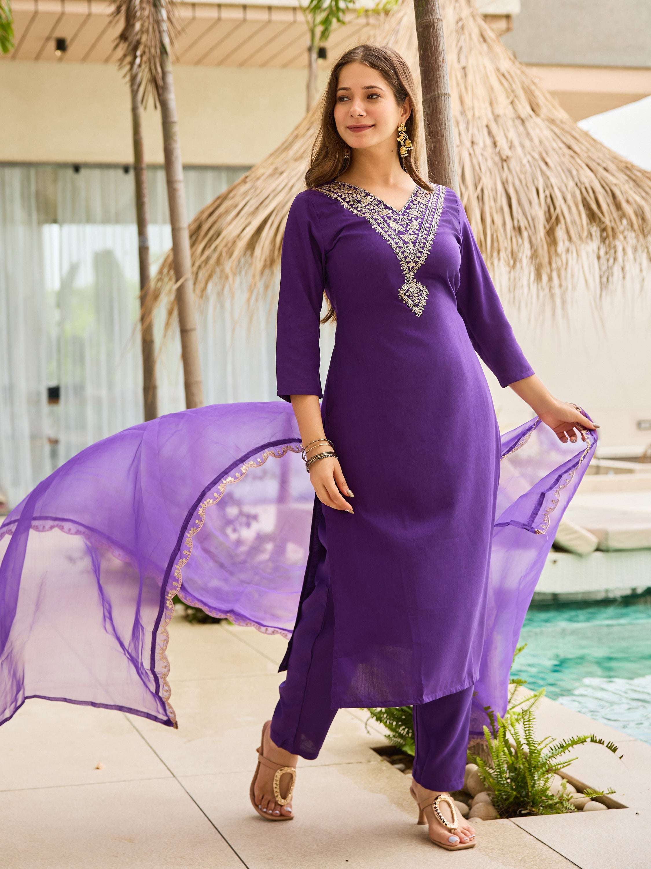 TRENDBUY model gracefully poses in violet kurti set with flowing organza dupatta by pool