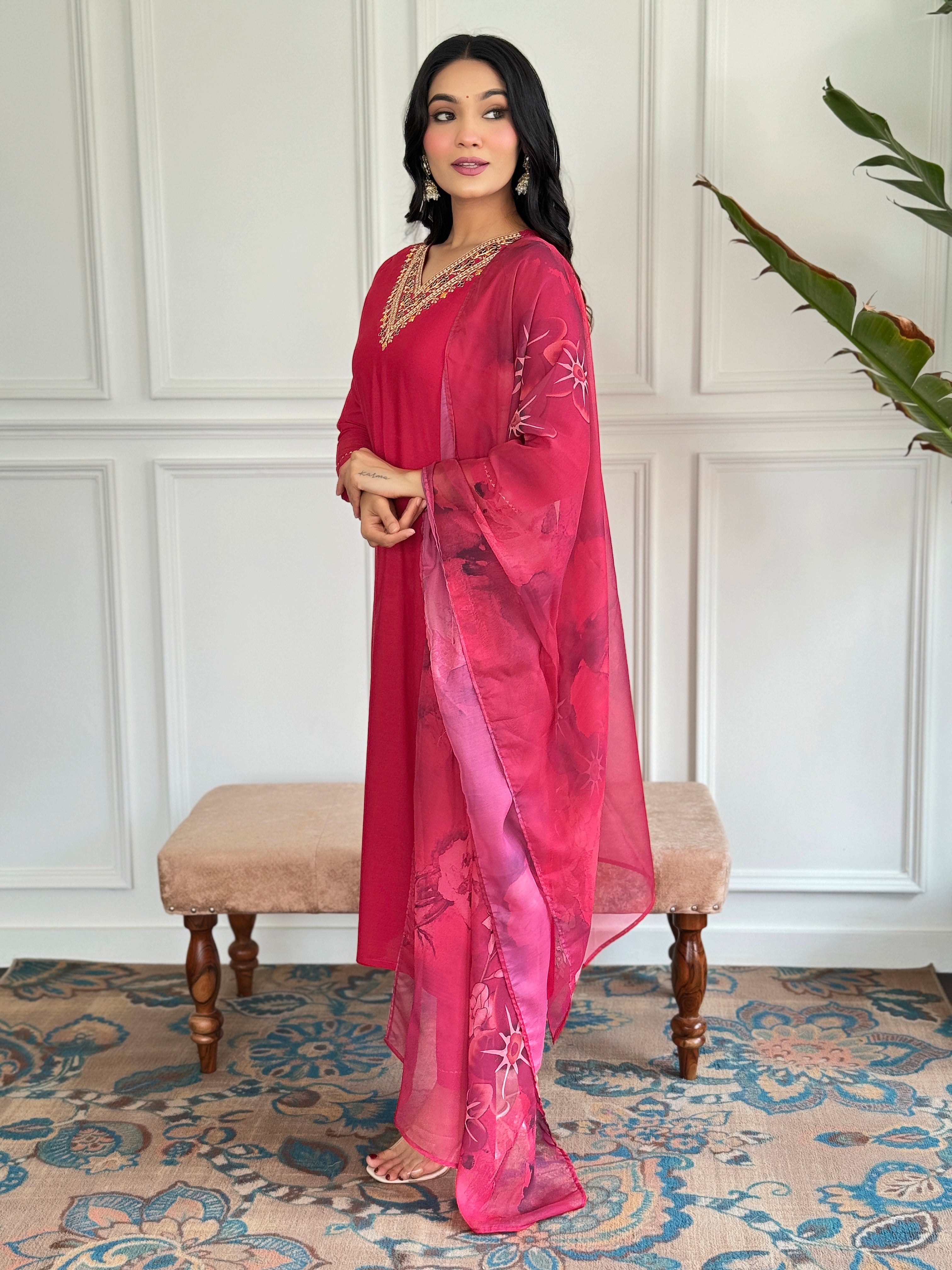 Side profile of the model in the TRENDBUY red rayon kurta set, highlighting the straight cut of the kurta and the drape of the silk printed dupatta.