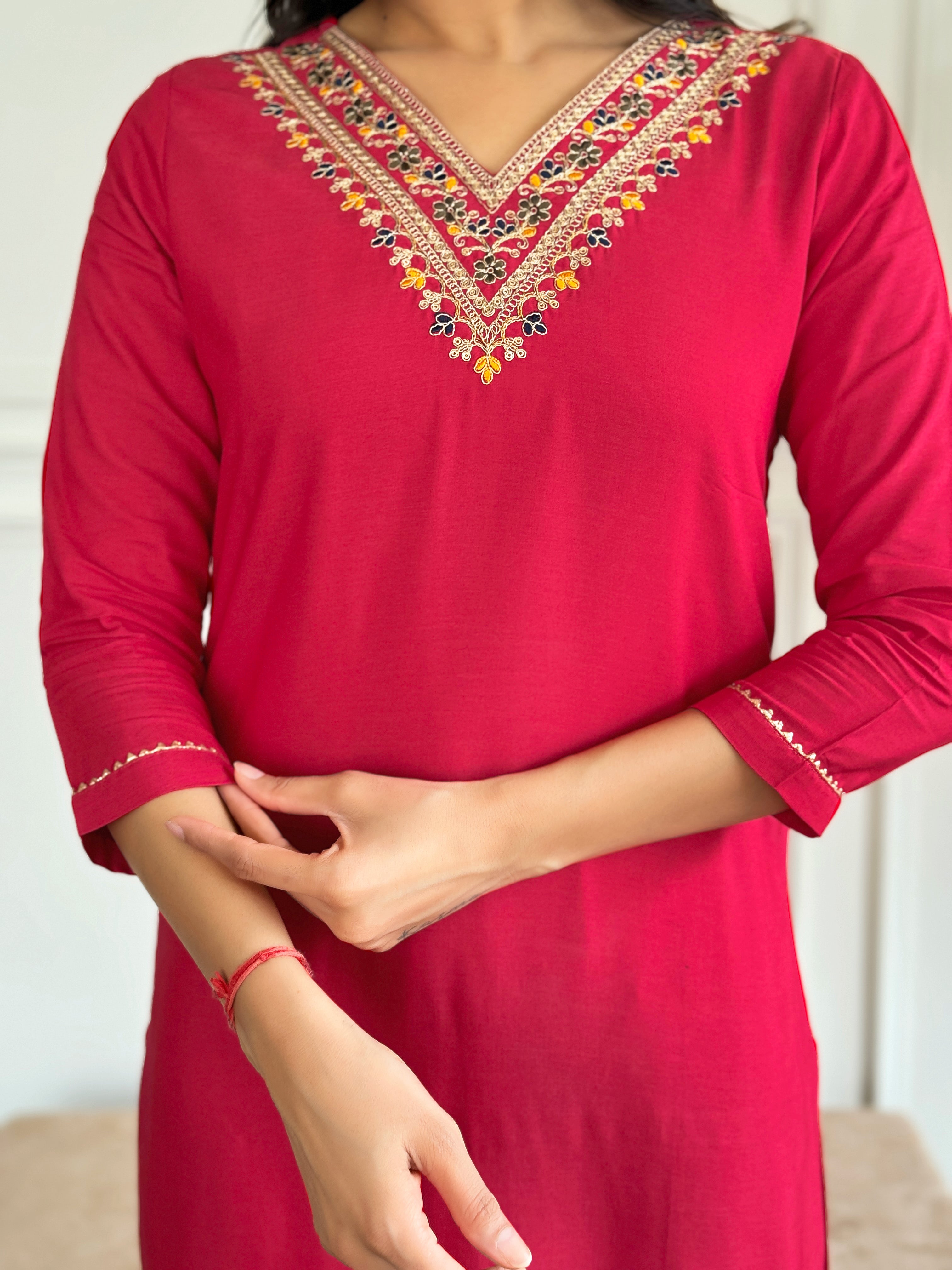 Close-up detail of the exquisite multi-colored embroidery on the V-neckline of the red rayon kurta from TRENDBUY.