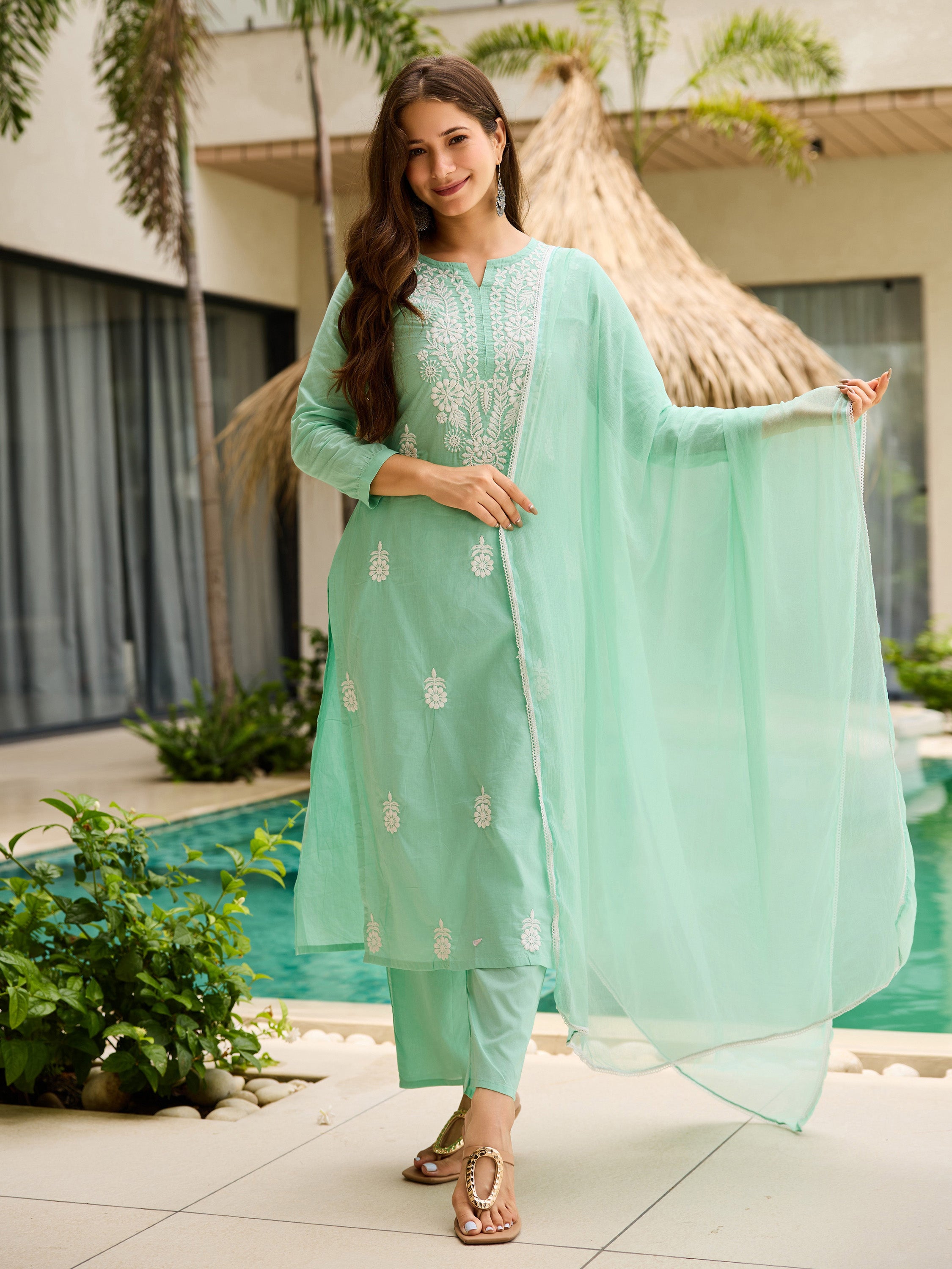 TRENDBUY woman smiling in turquoise embroidered cotton kurta set by a pool