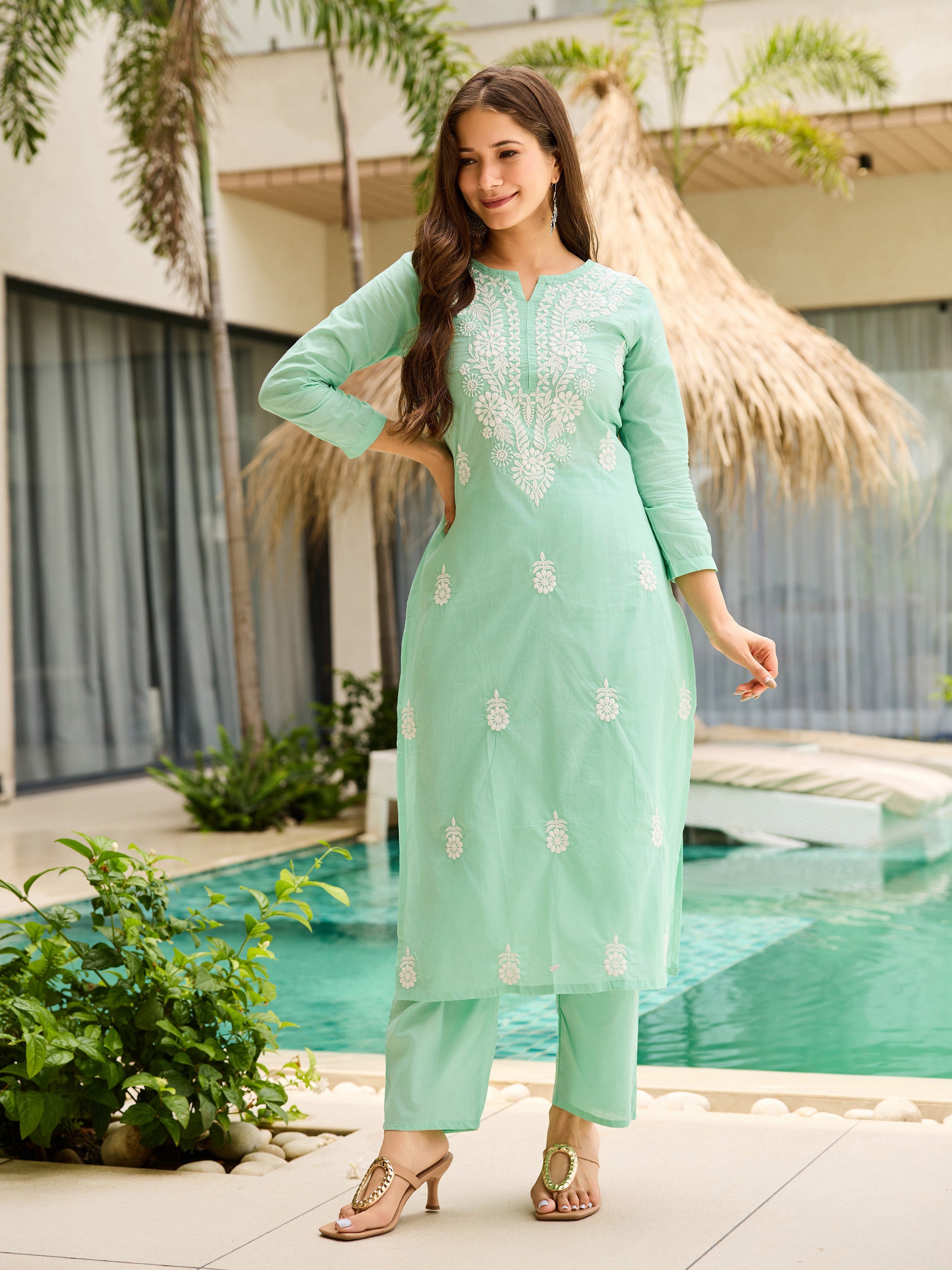Woman in elegant turquoise kurta set, hand on hip, showcasing the comfortable fit and style
