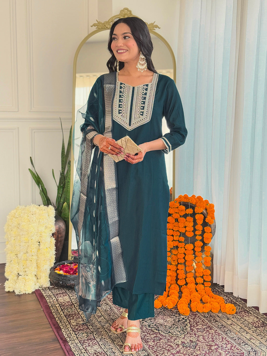 Woman smiling brightly, showcasing the complete look of the teal embroidered kurti set with matching pants and floral organza dupatta.