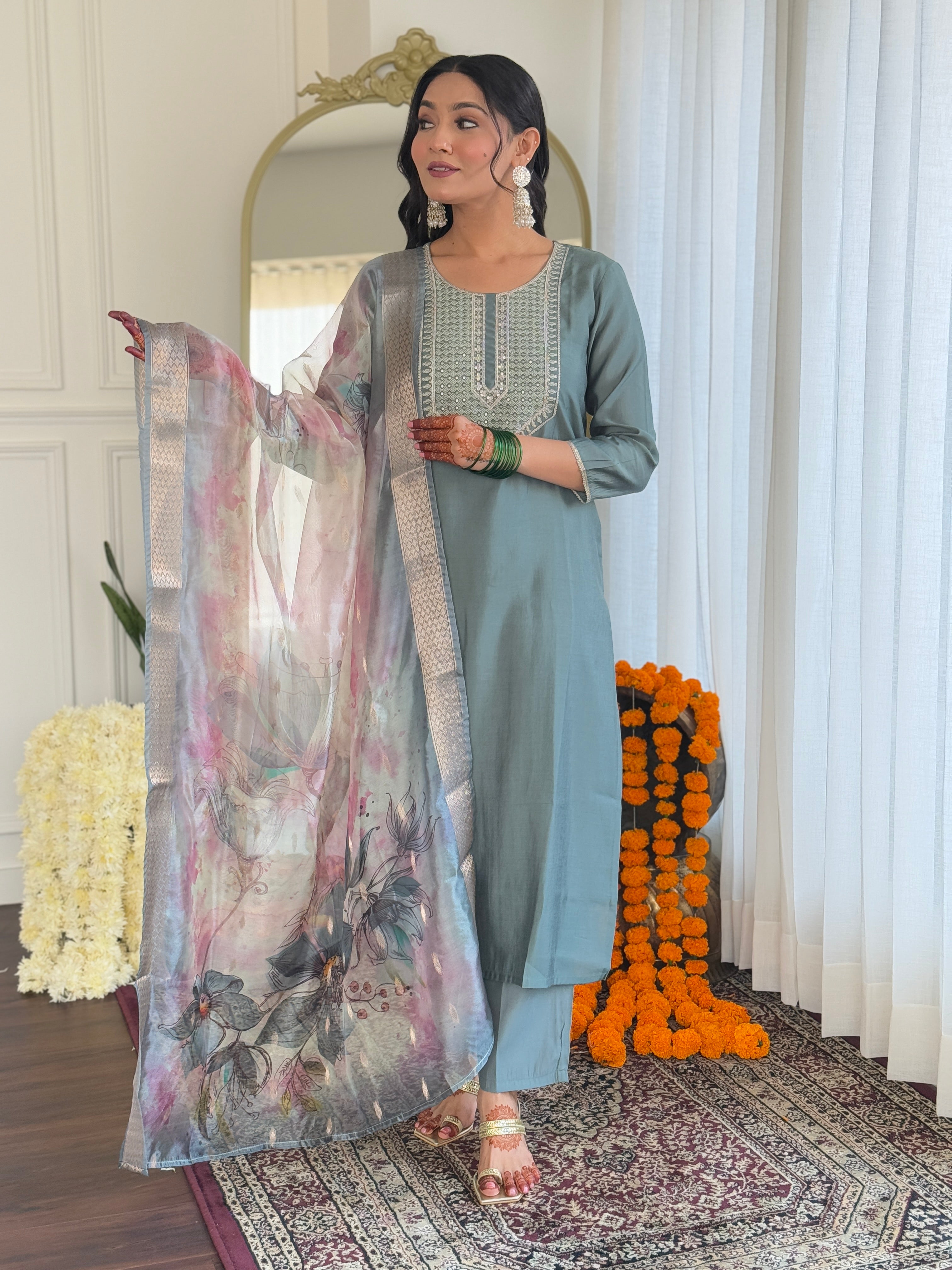 Woman posing gracefully in the Pista green kurti set, holding out the beautiful floral organza dupatta to showcase its design and drape.