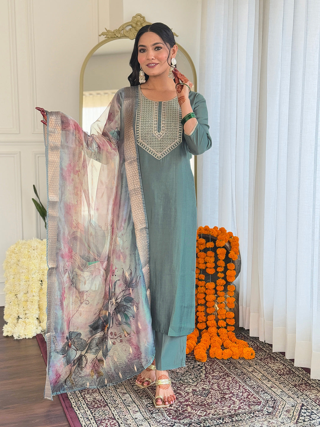 Full-length shot of a cheerful woman modeling the Pista green BSY Viscose kurti and pants with the sheer, printed organza dupatta.