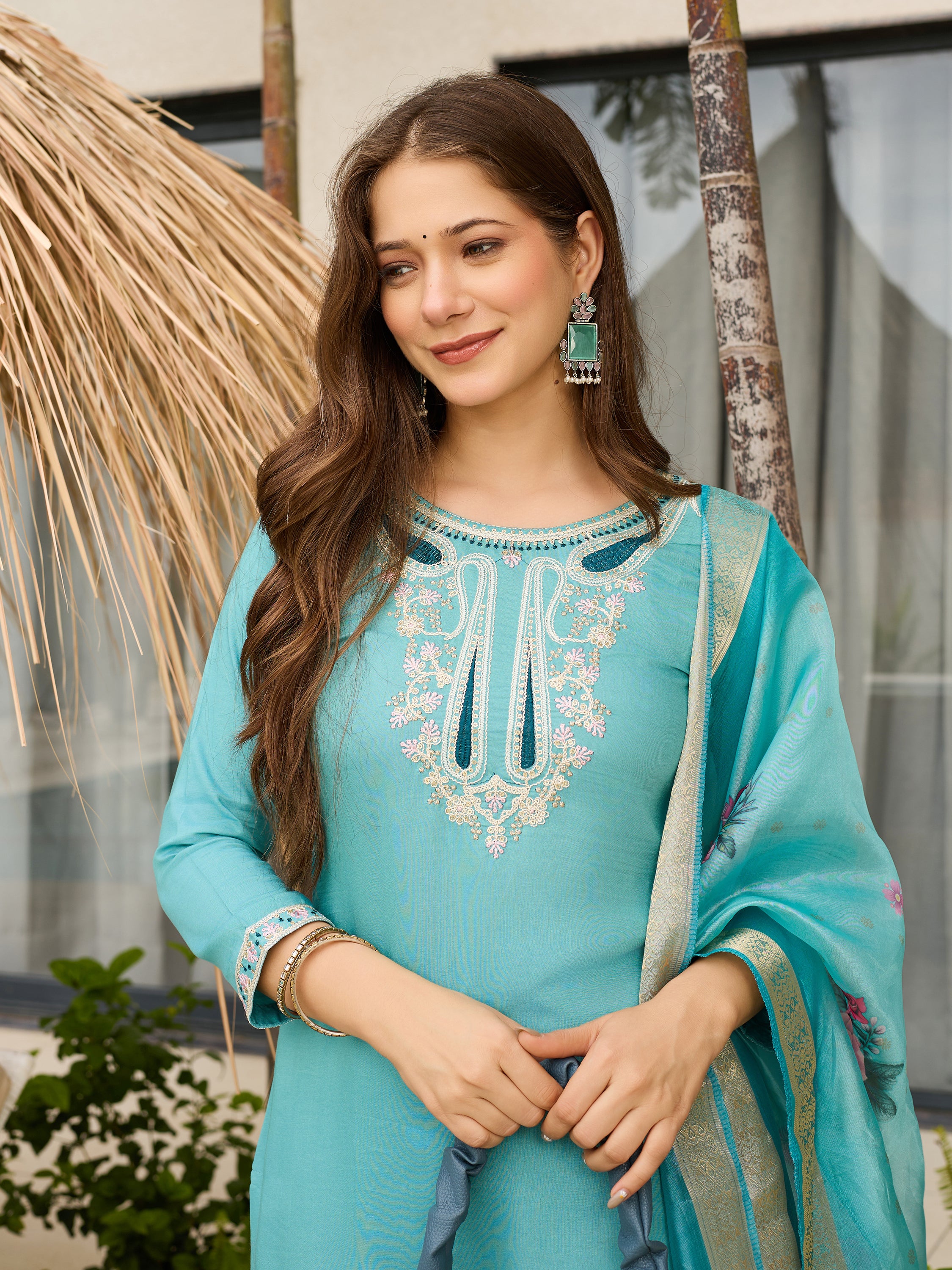 Portrait shot of the model, focusing on the beautiful embroidery, teal earrings, and the overall graceful look of the kurti set.