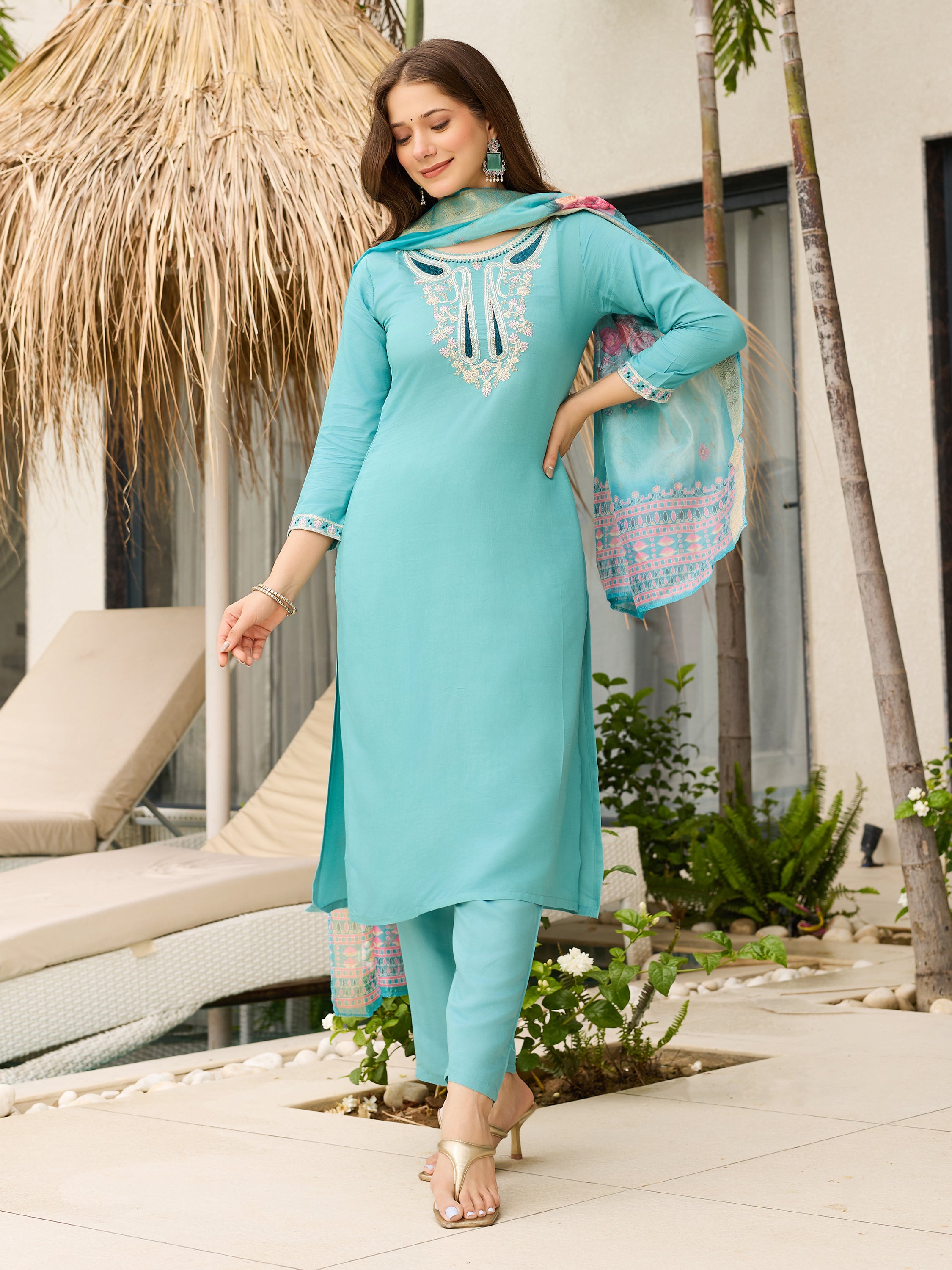 Model in a relaxed pose, showing the flow and comfort of the teal blue viscose kurti with its matching pant and organza dupatta.
