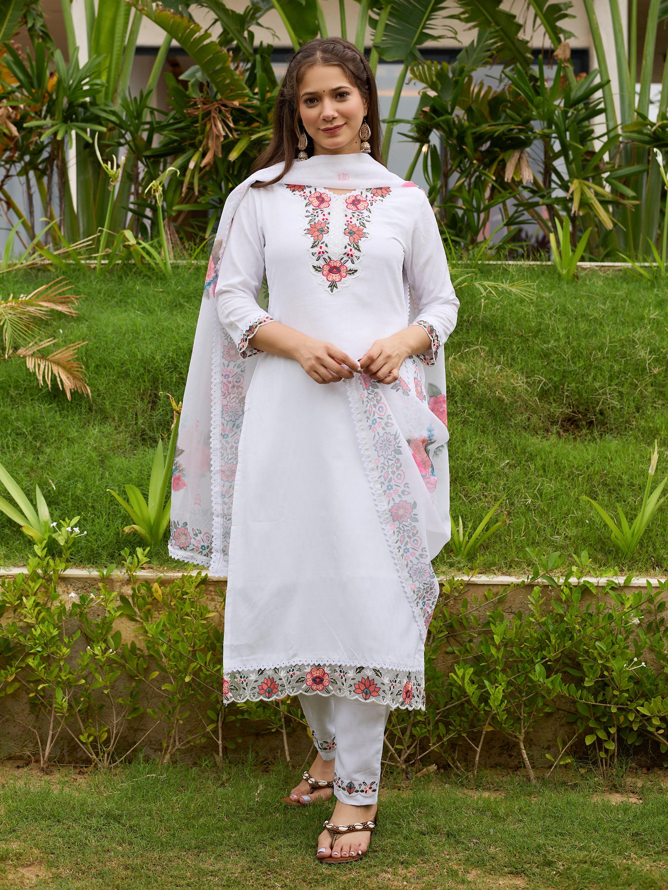 TRENDBUY model showcasing the full white embroidered viscose kurti with pant and taby dupatta set, standing elegantly in a garden.
