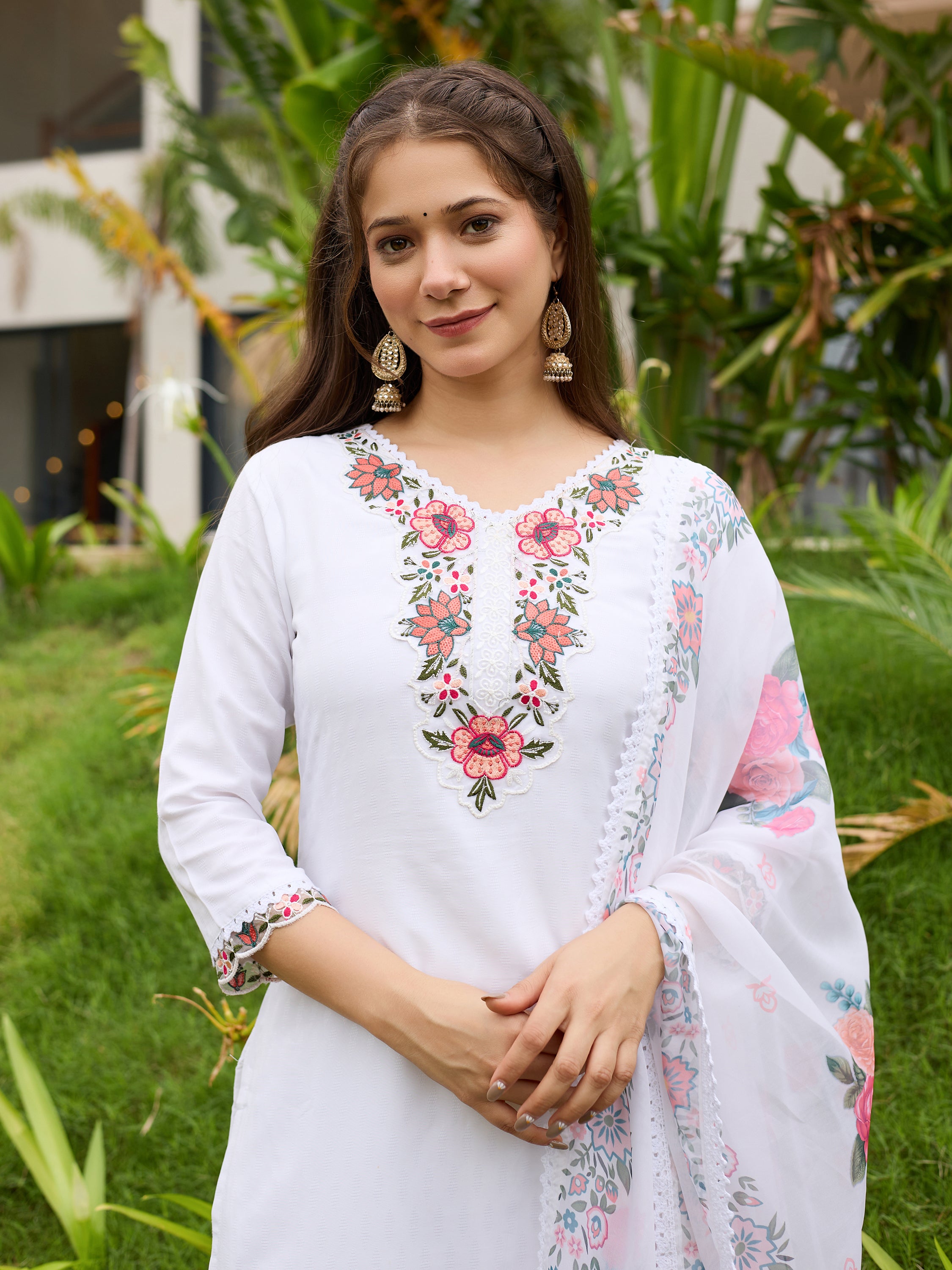 Portrait of the TRENDBUY model smiling, wearing the white embroidered kurti set, showcasing the detailed neck embroidery and earrings.