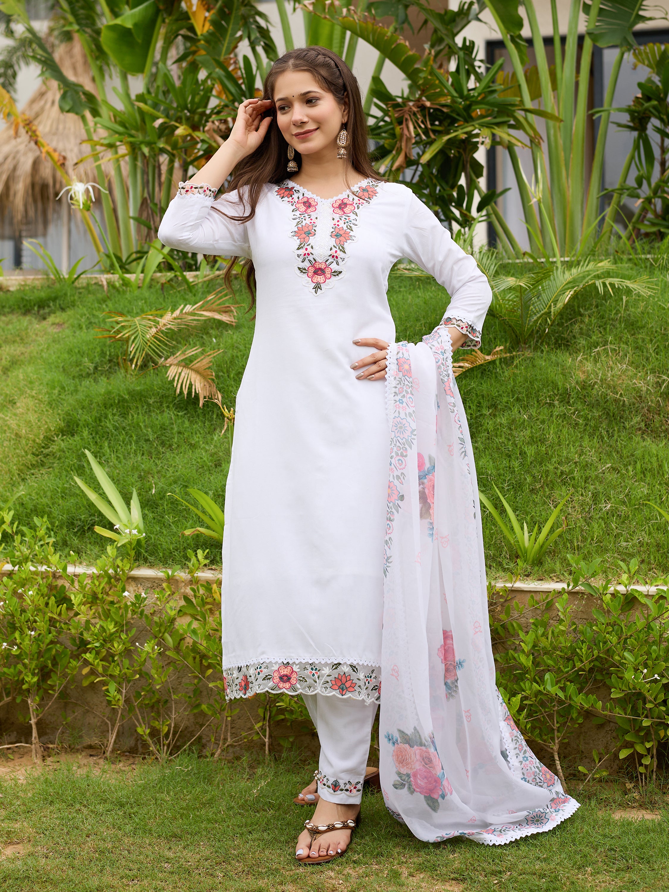 TRENDBUY model striking a confident pose in the white embroidered kurti set, with one hand on her hip and the dupatta draped.