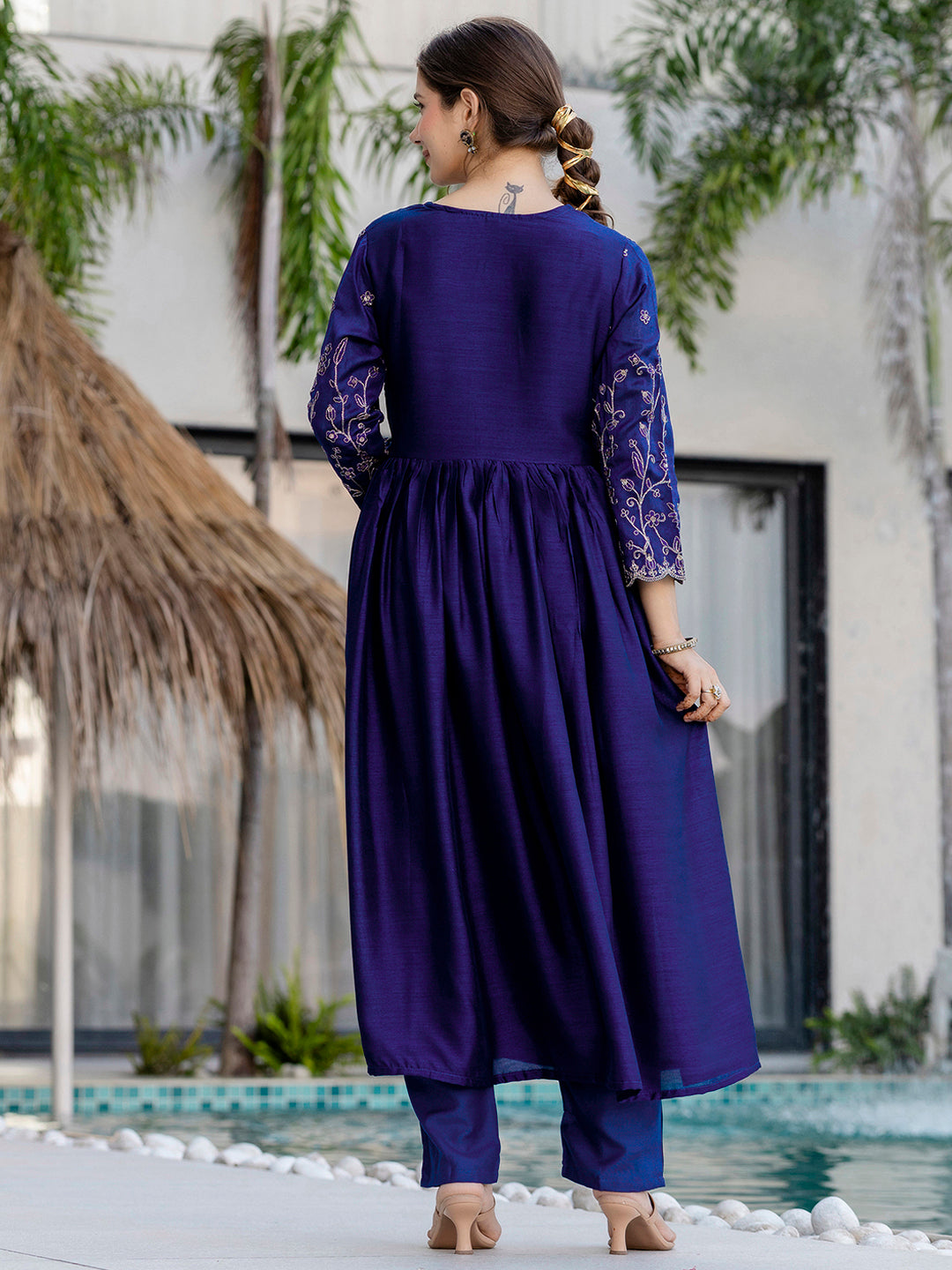 Back view of blue Vichitra silk kurta set showing pleated detailing, embroidered sleeves, and graceful flow