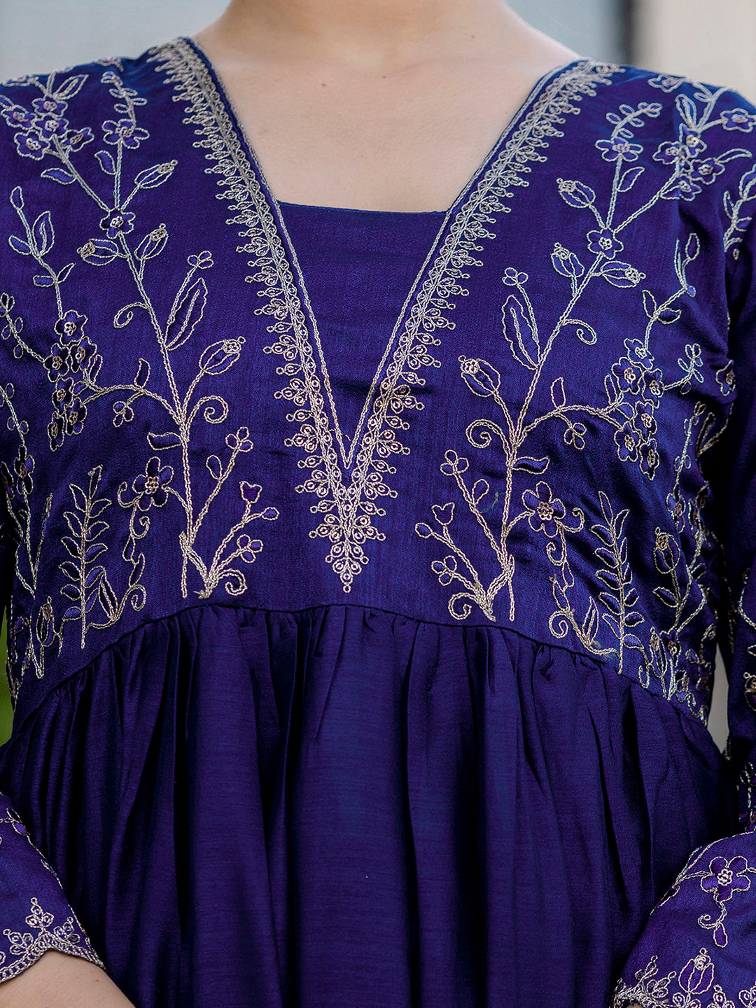 Close-up of blue kurta neckline featuring delicate gold embroidery on Vichitra silk fabric, highlighting craftsmanship