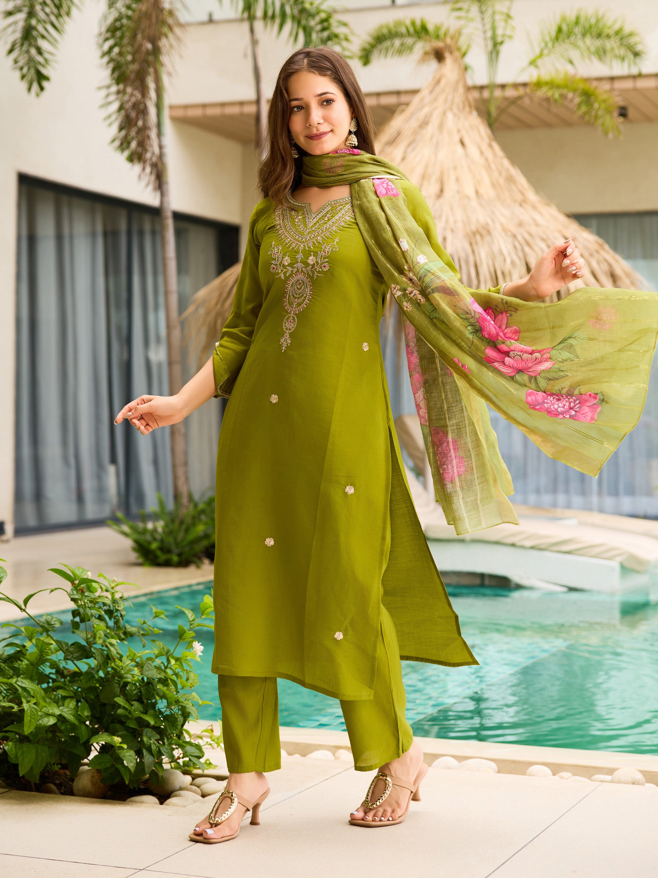 TRENDBUY model posing elegantly in a lime green embroidered kurti set, dupatta draped over shoulder, by the pool