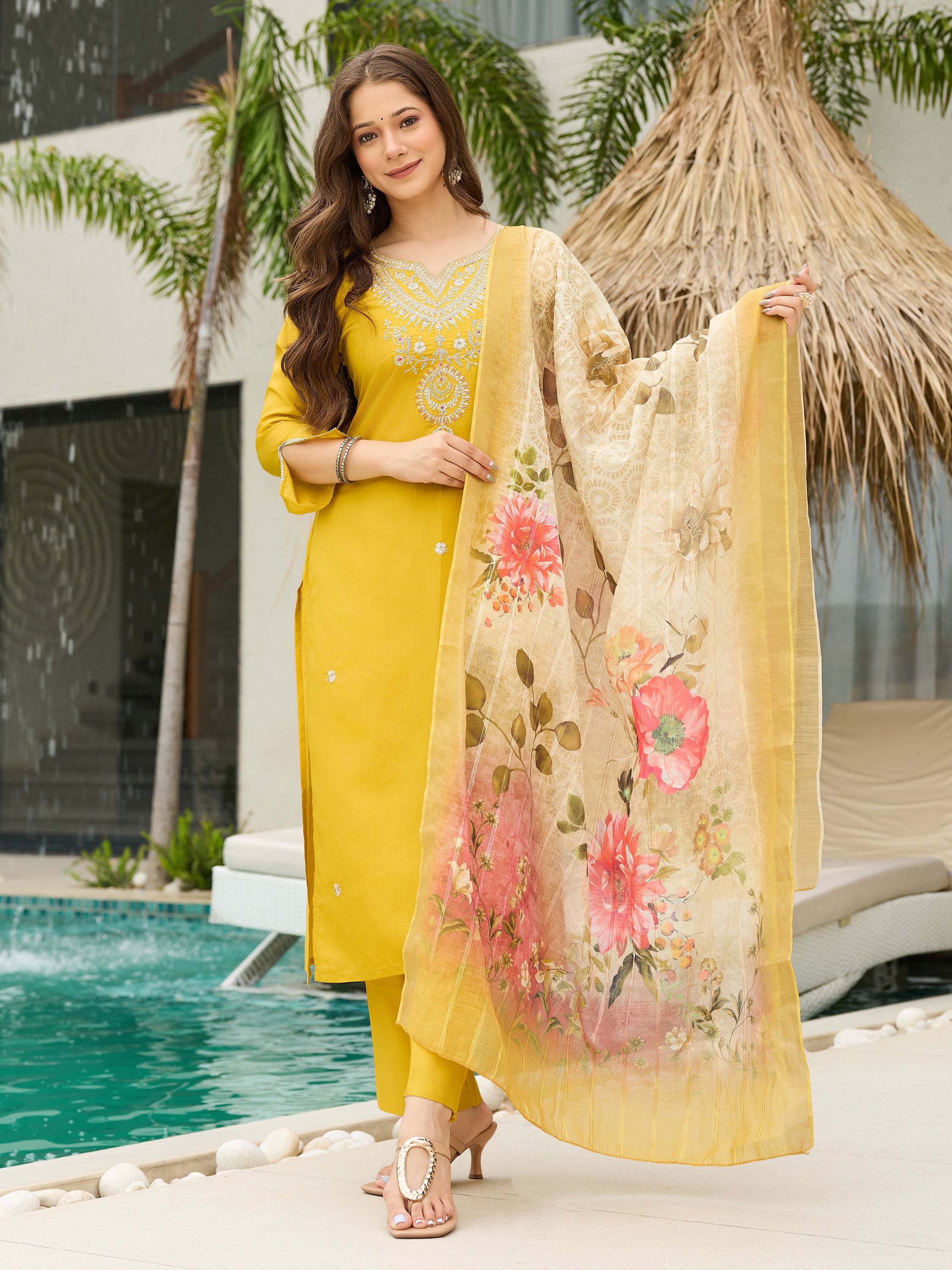 TRENDBUY model in a vibrant mustard yellow embroidered viscose kurti set with floral jacquard dupatta, by a pool