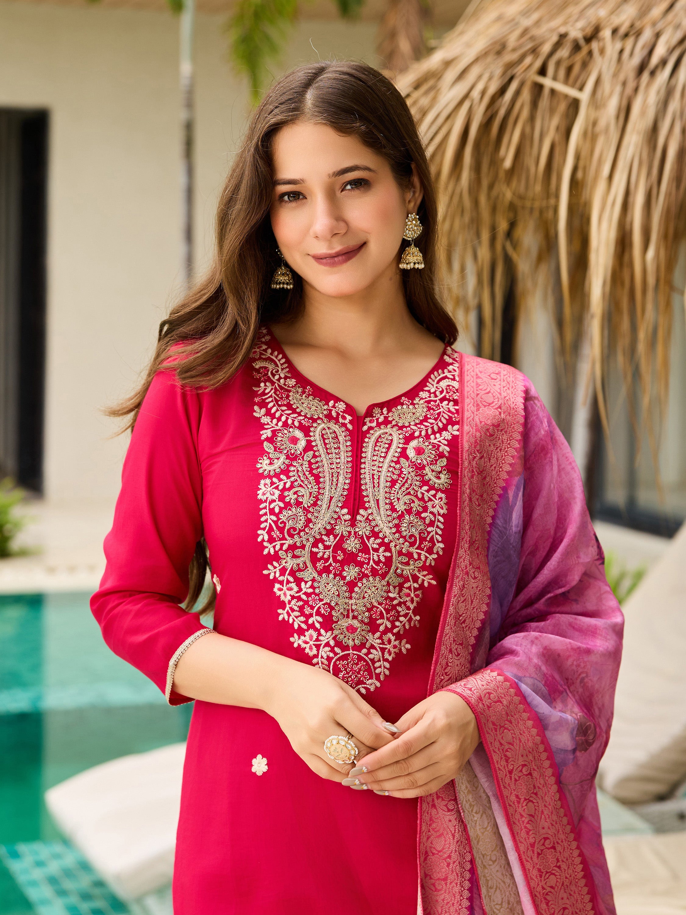 Smiling TRENDBUY model highlighting the detailed embroidery and overall look of the pink kurti set.