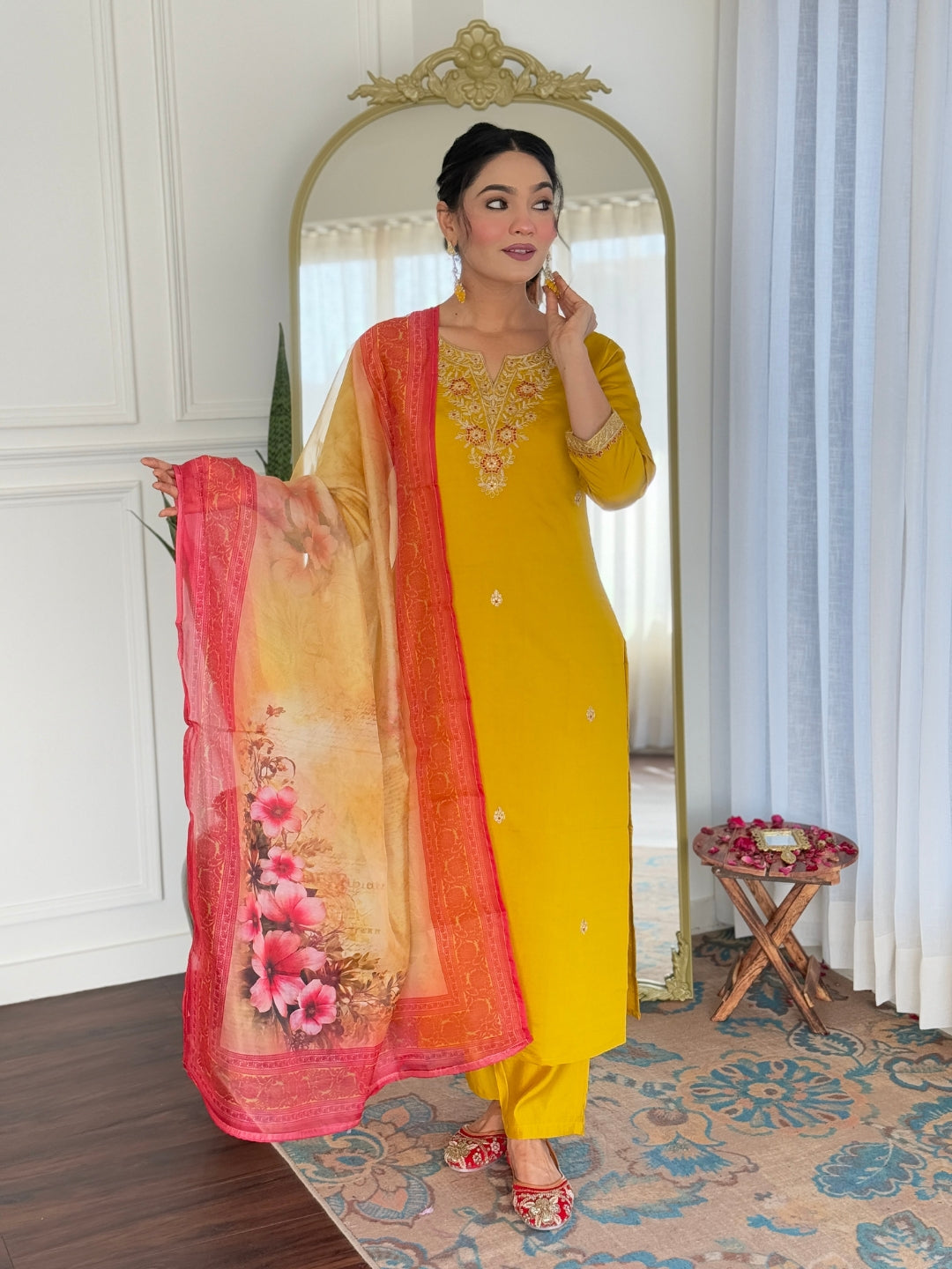 Elegant model in mustard rayon kurti set with embroidered neckline and floral printed taby dupatta, posing indoors