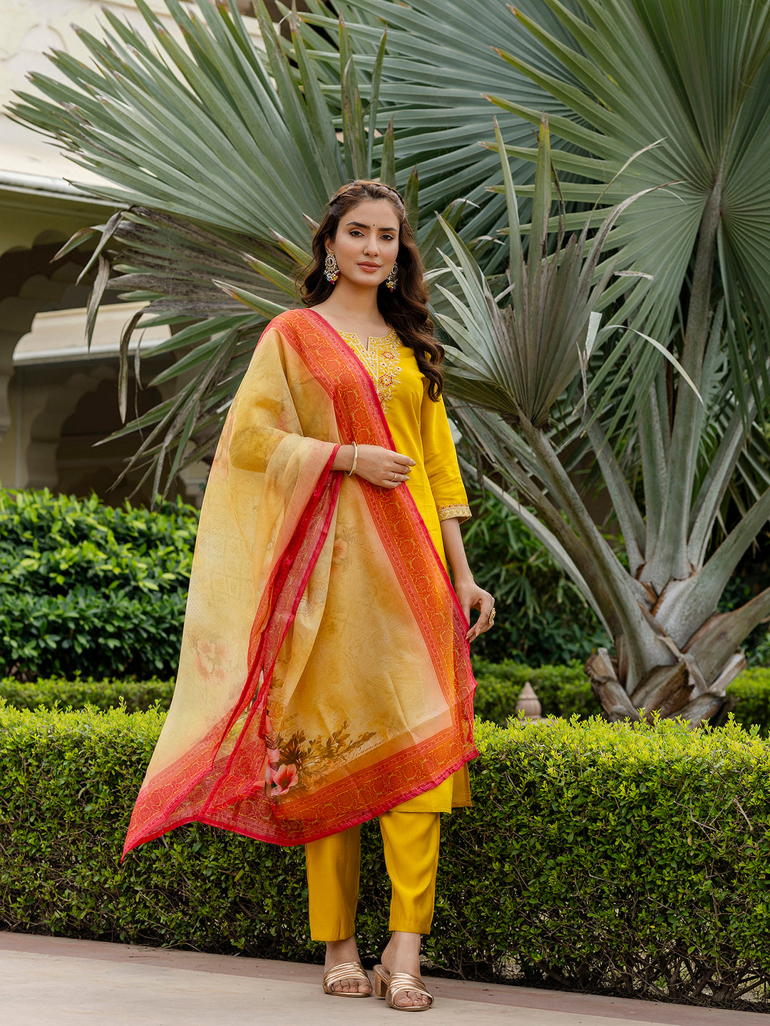 Model posing outdoors in the mustard rayon kurti set with a vibrant floral taby dupatta, highlighting the mustard color