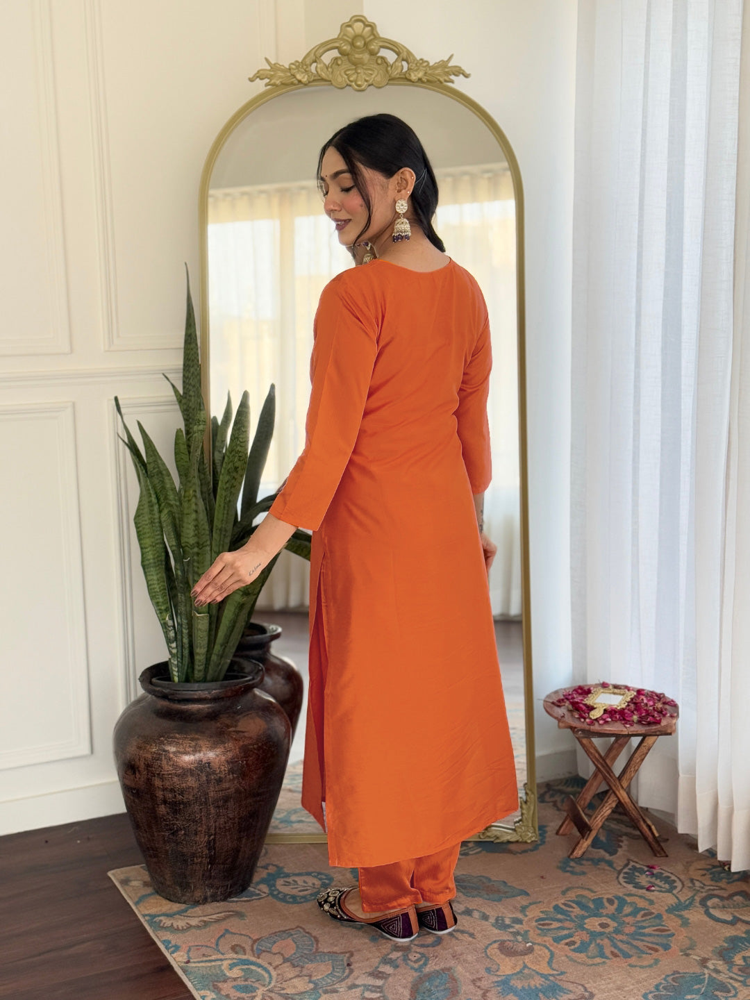 Back view of the orange rayon kurti and pant set, highlighting its simple yet elegant design.