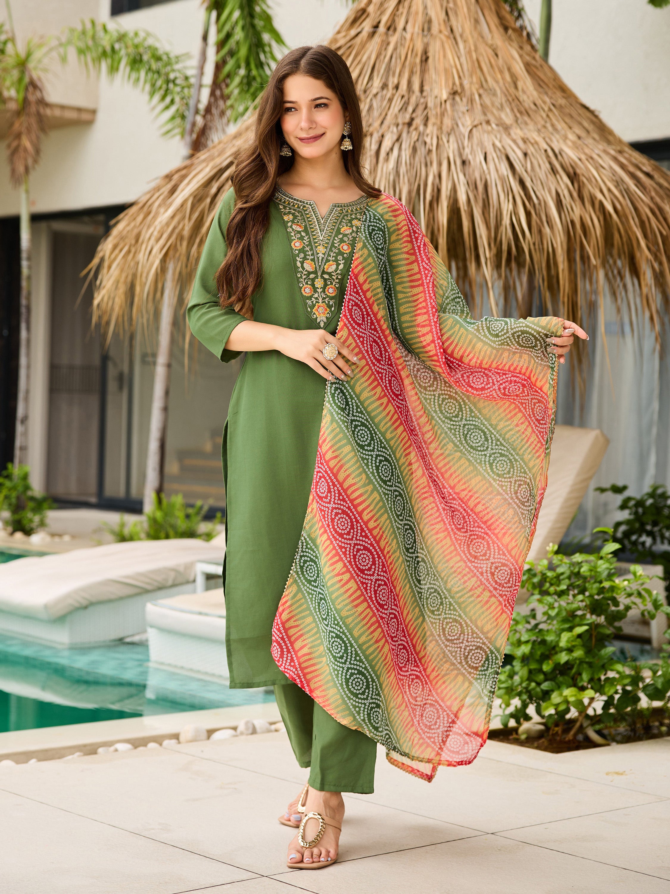 Model in Mahendi green embroidered rayon kurta set with vibrant patterned dupatta by pool, TRENDBUY.