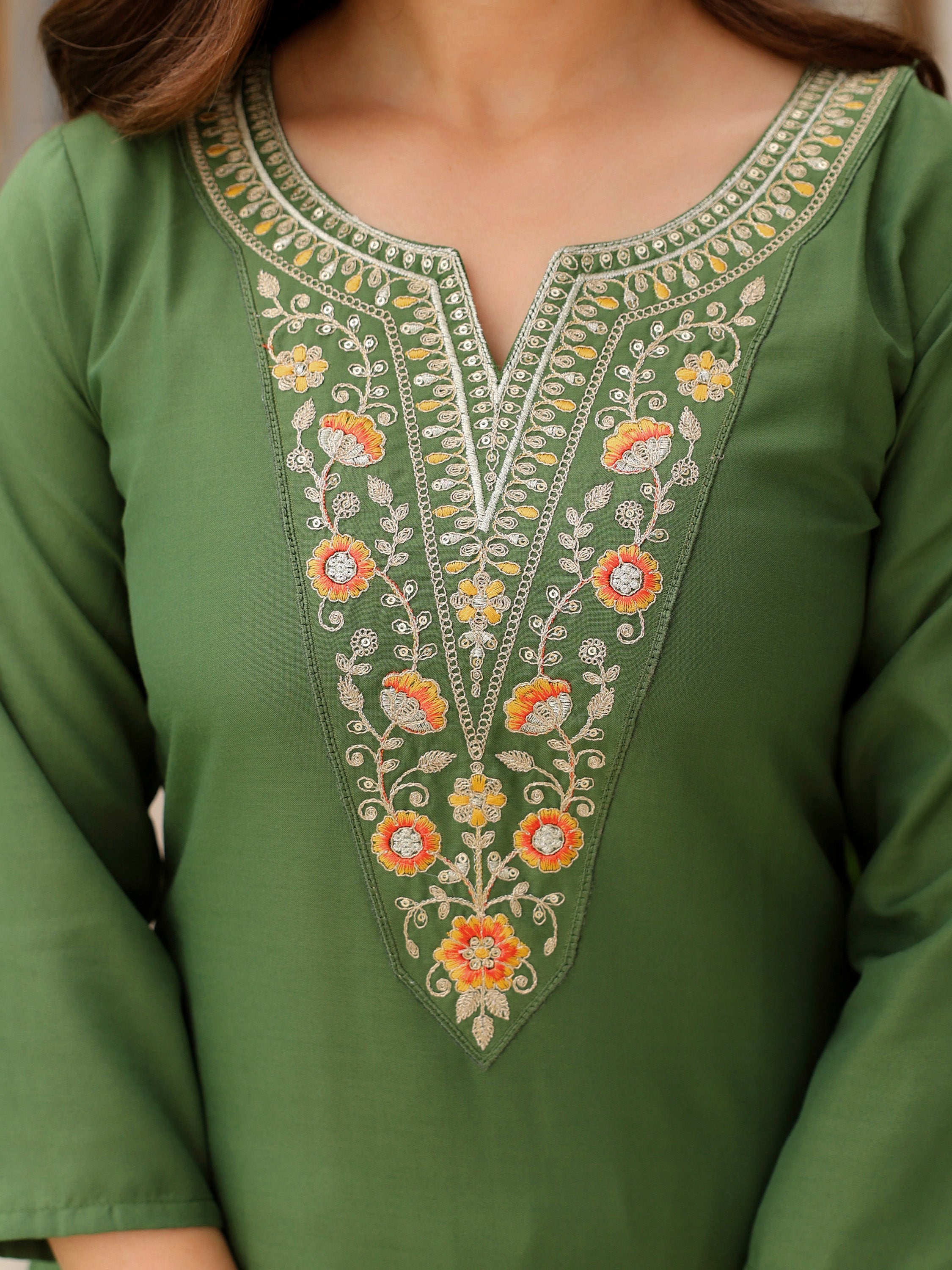 Close-up of intricate colorful embroidery on the V-neck of the Mahendi green rayon kurta, TRENDBUY.
