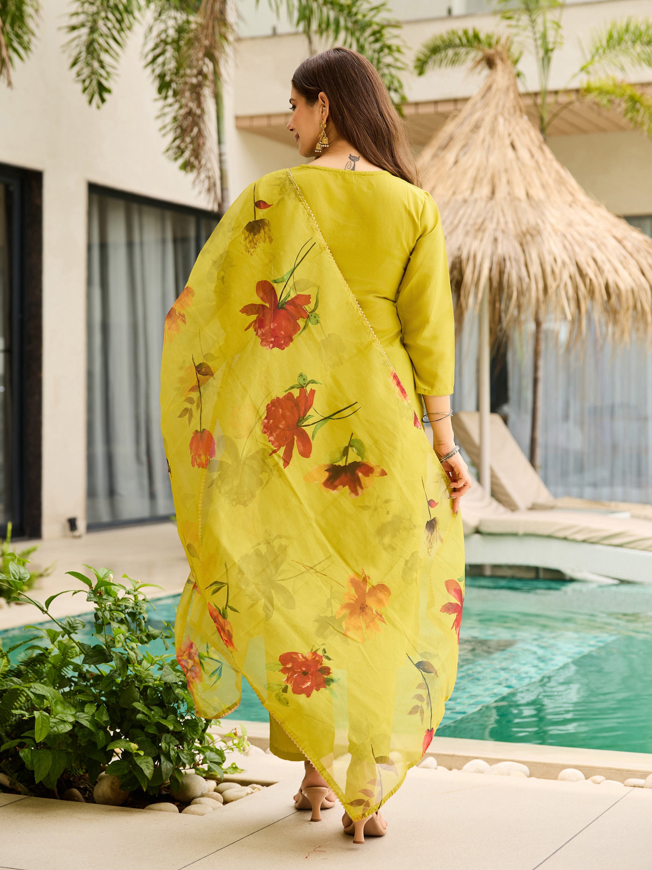 Back view of the Liril Green Kurti Set, highlighting the flowing floral taby dupatta against a resort backdrop.