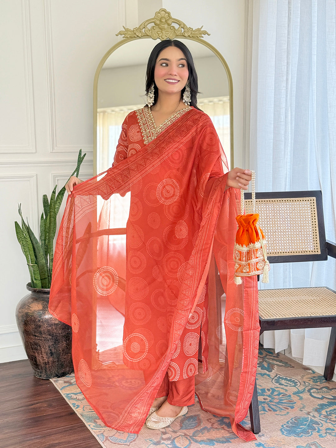 TRENDBUY model gracefully posing in the D732 orange kurti set, displaying the flowing taby dupatta with border details.