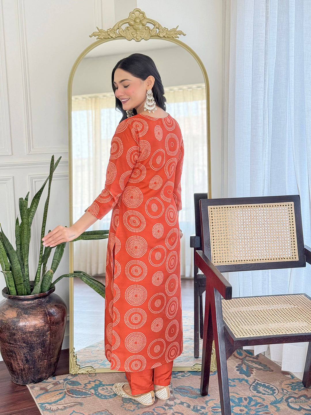 Back view of TRENDBUY model in D732 orange kurti set, highlighting the full geometric print on the rayon fabric.