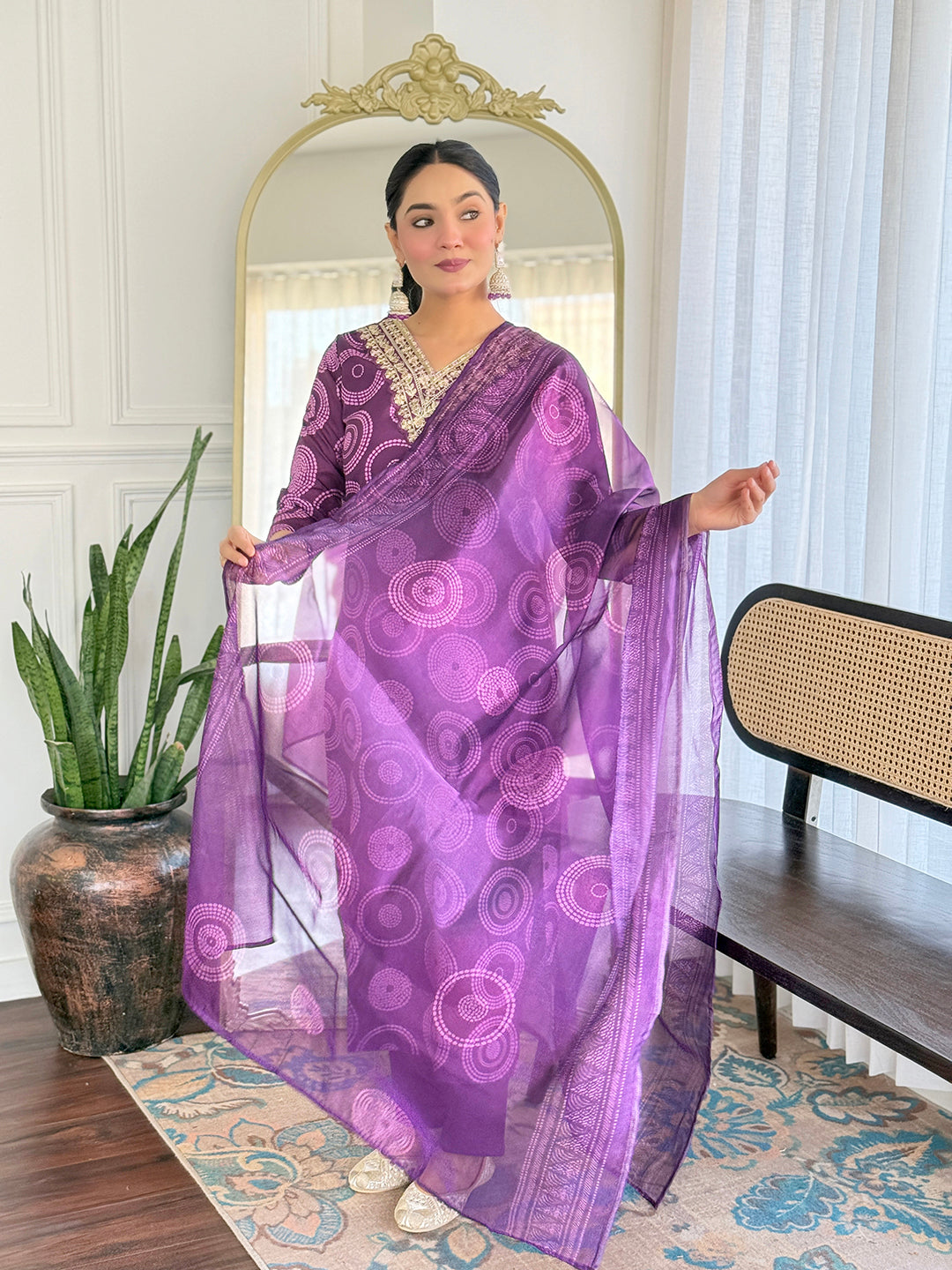 TRENDBUY model elegantly presenting the D732 purple kurti set, gently holding out the matching taby dupatta.