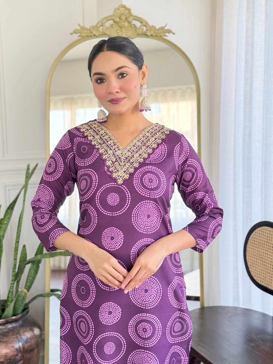 Close-up of the D732 purple kurti's V-neckline with ornate golden embroidery, worn by the TRENDBUY model.