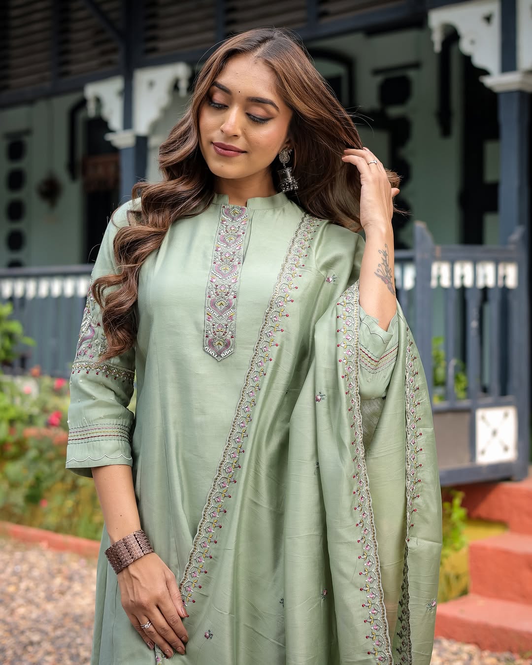 TRENDBUY Pooja Olive Green Muslin Silk Kurta Set with intricate neckline embroidery, modeled by a woman with long wavy hair.