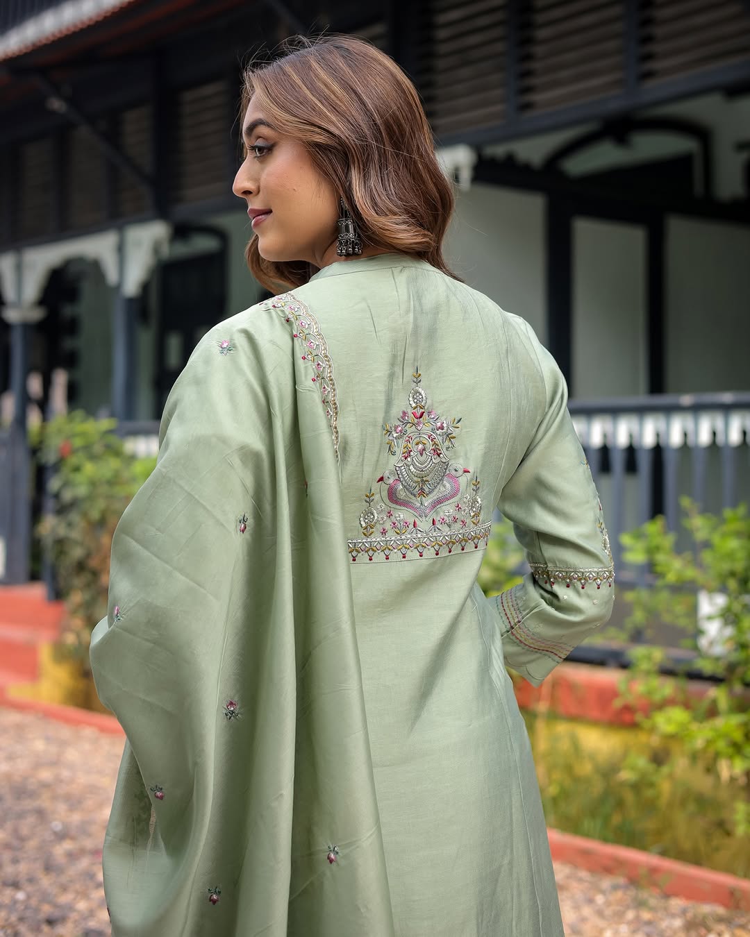 Rear view of the TRENDBUY Pooja Olive Green Kurta Set, emphasizing the detailed embroidery on the back of the kurta and the flowing dupatta.