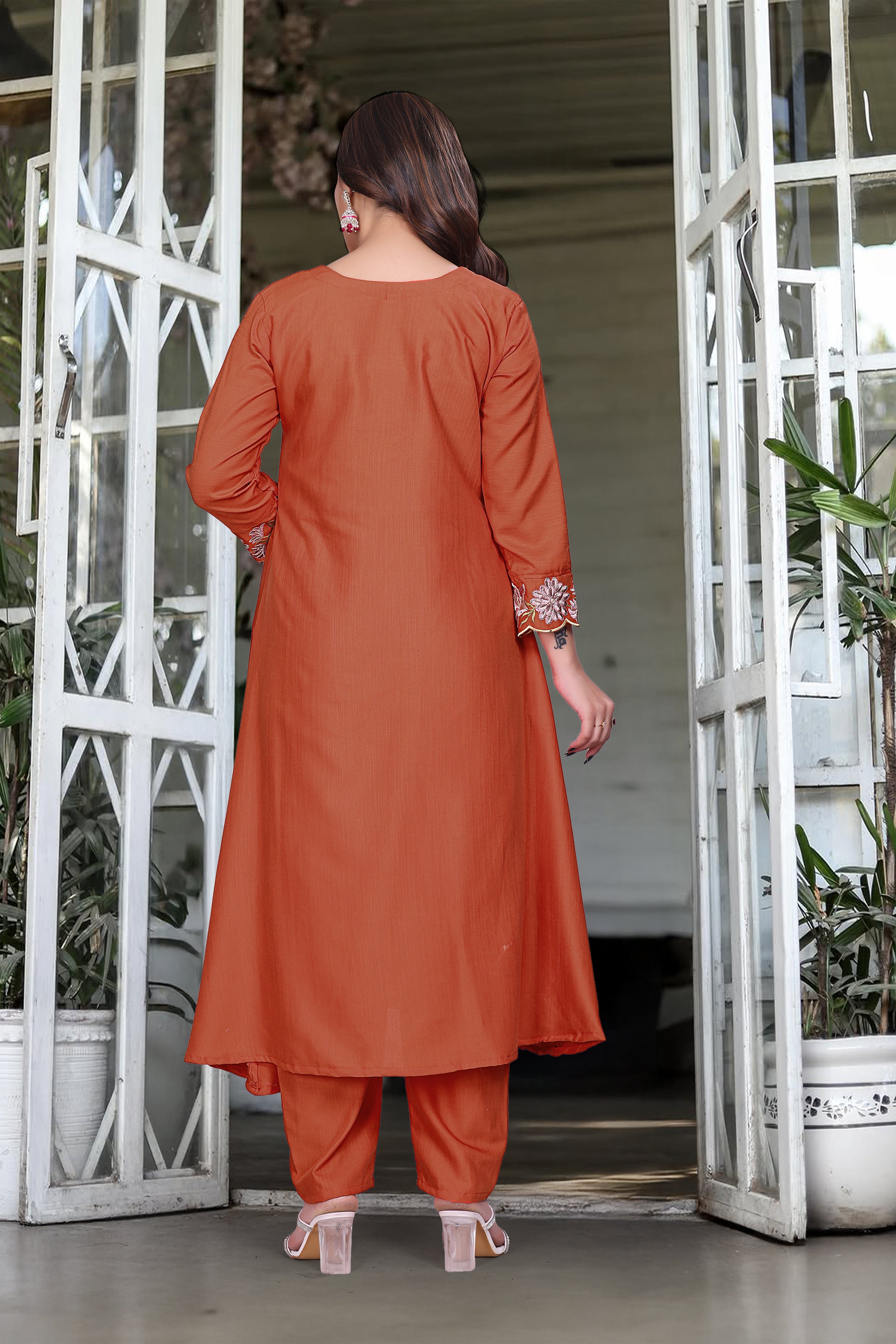 Back view of model in orange rayon slub kurti set, showcasing the simple back of the kurti and straight-fit pants.