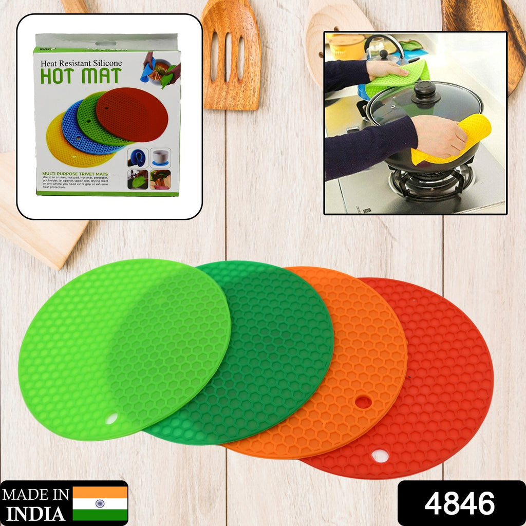 Set of 4 colorful silicone hot mats for hot vessels and utensils, preventing marks on surfaces.