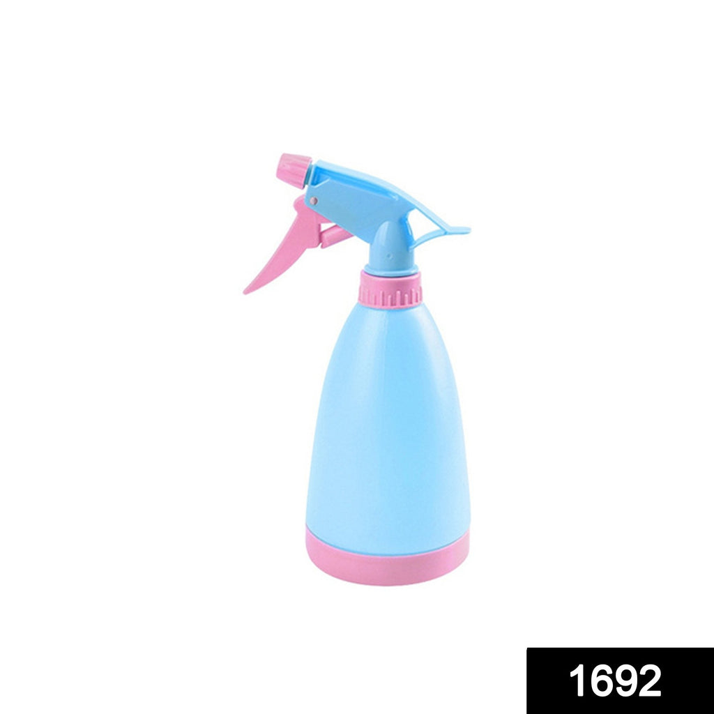 Multipurpose home garden water spray bottle misting a green plant
