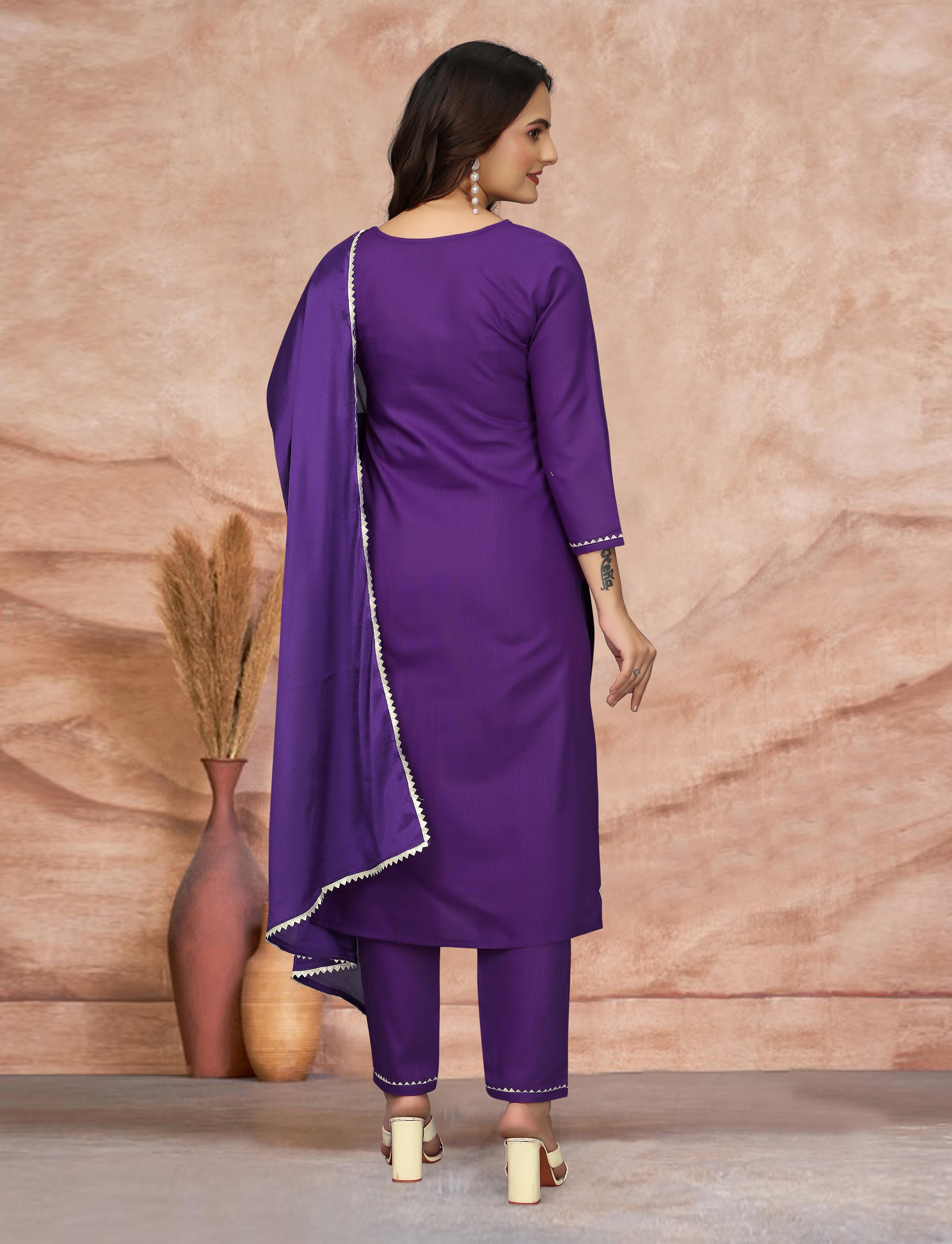 Back view of woman in vibrant purple embroidered kurti and pant, with silk dupatta.