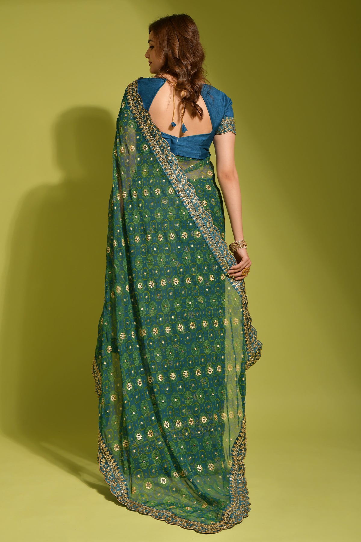 Exquisite petrol blue Georgette Chiffon Saree with delicate flower print, shimmering foil, and sequin work.