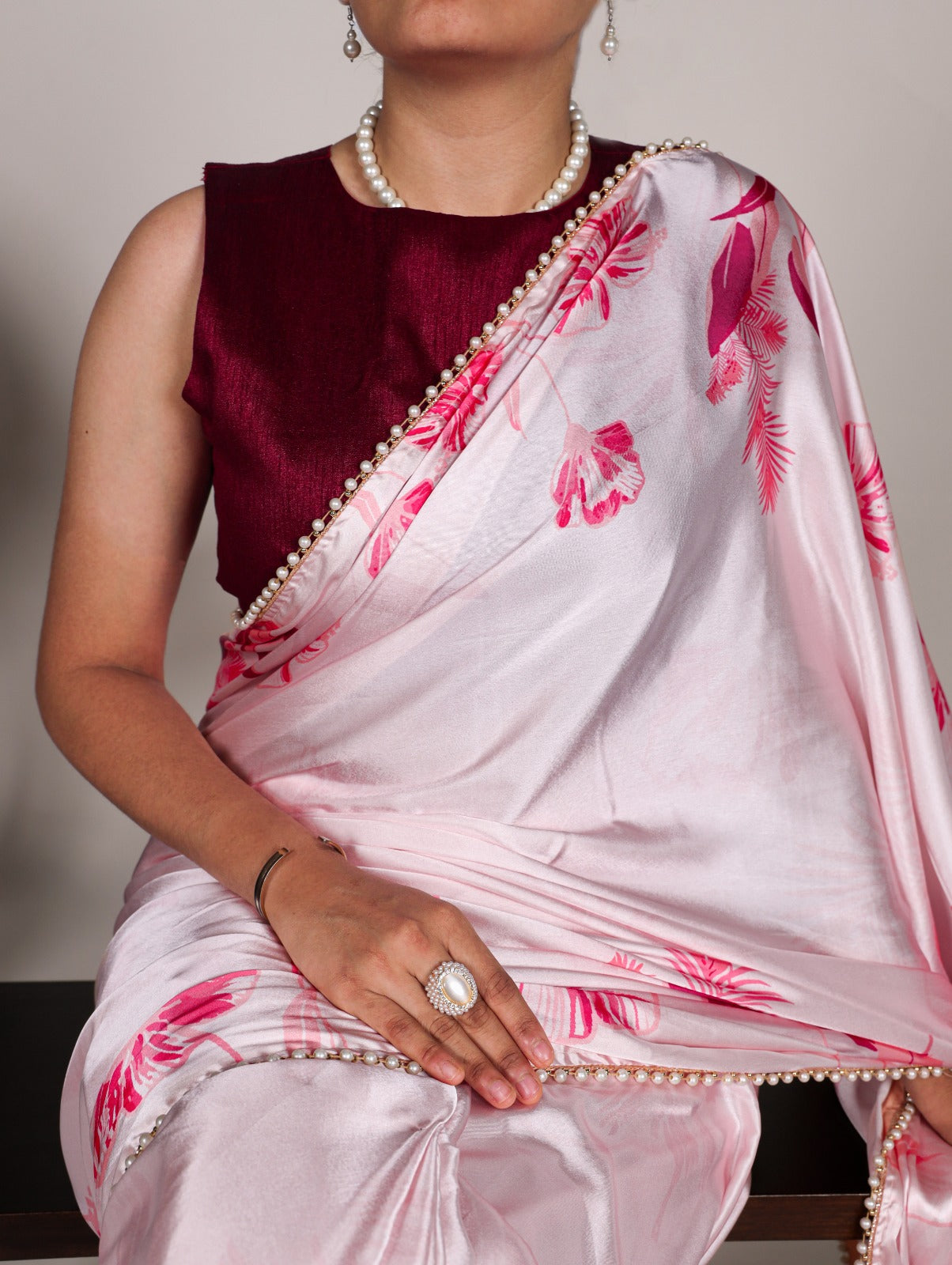 Pink Japan satin silk saree with digital floral print and elegant pearl lace border.