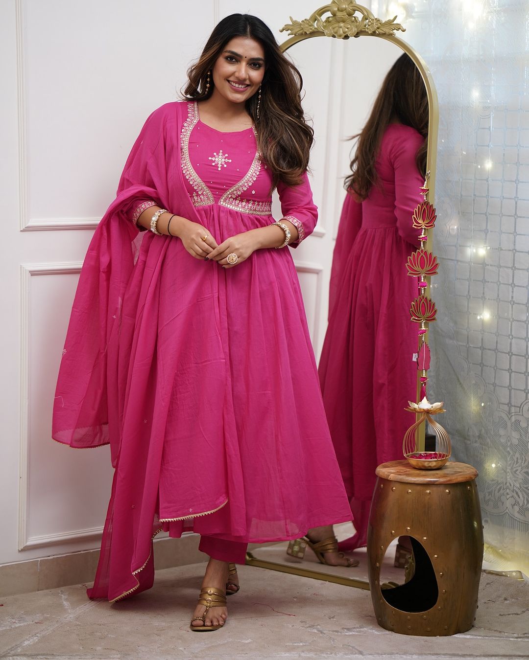 Front view of a woman confidently posing in the pink Muslin Cotton embroidered kurta set, highlighting the overall design and fit.