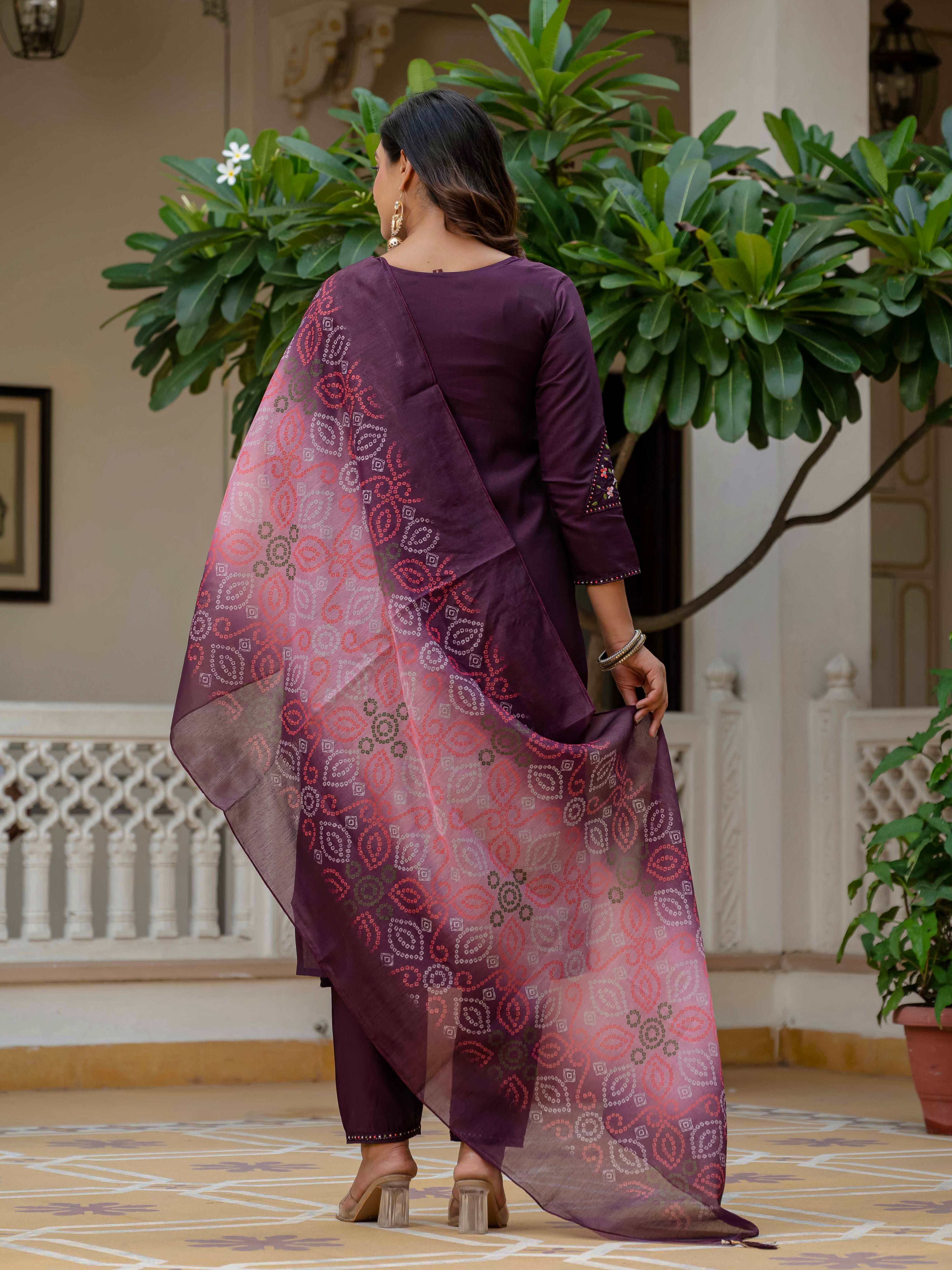 Model showcasing the back view of the elegant plum embroidered kurti set with a flowing bandhani dupatta.