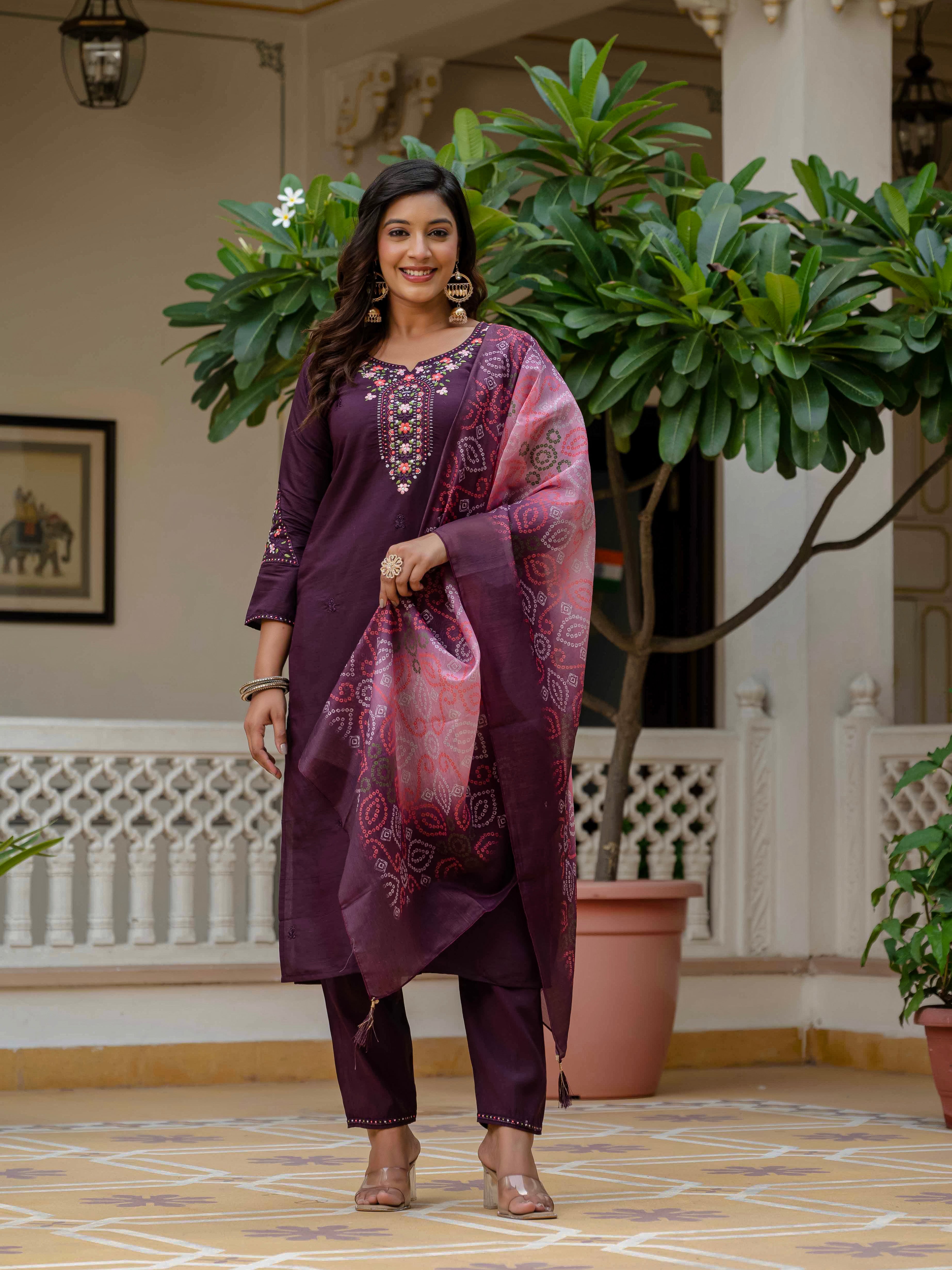 Front view of a happy model presenting the TRENDBUY plum kurti set, emphasizing the detailed embroidery on the neckline and sleeves.