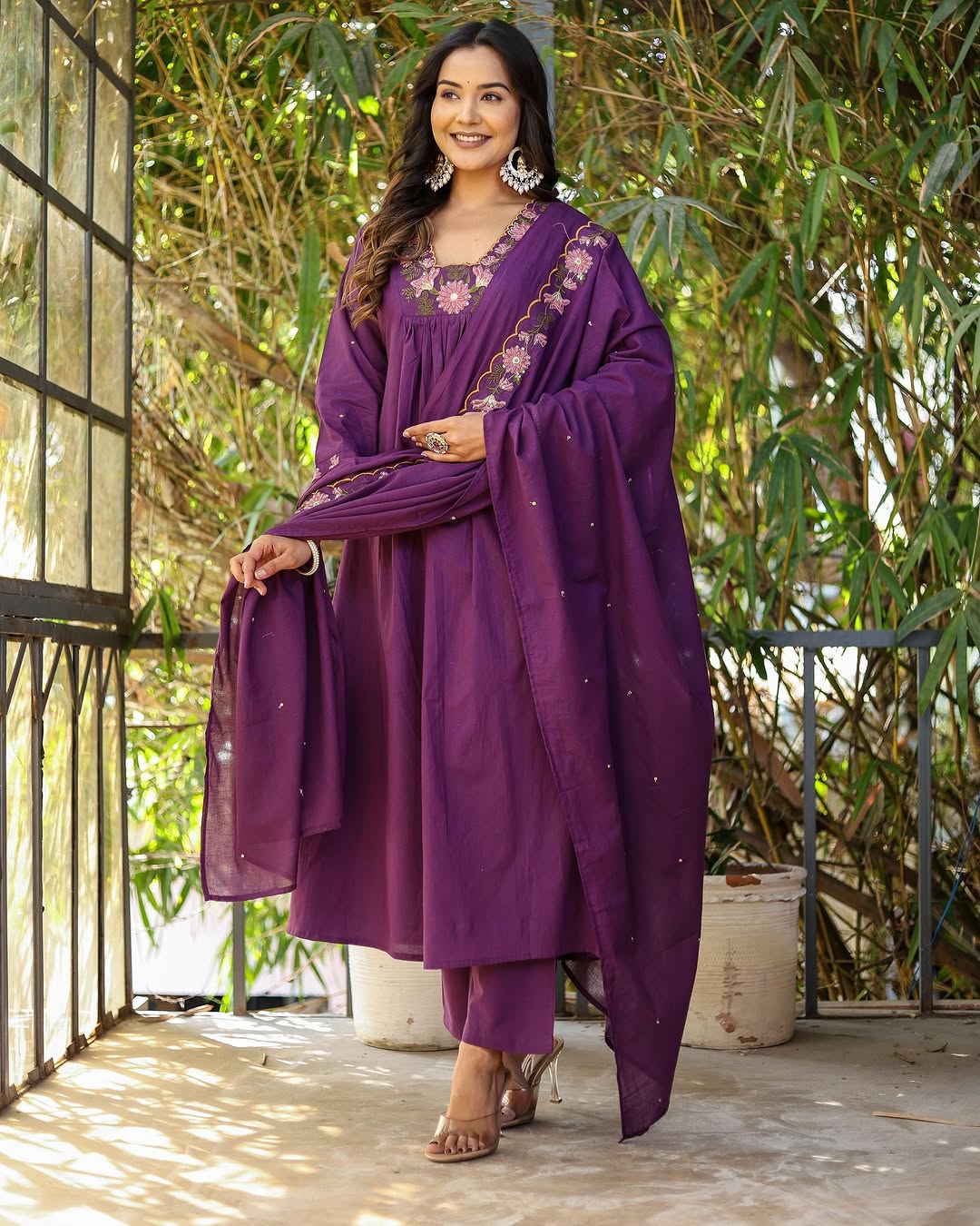 Model holding the embroidered chanderi dupatta of the purple kurti set, showcasing the design details.