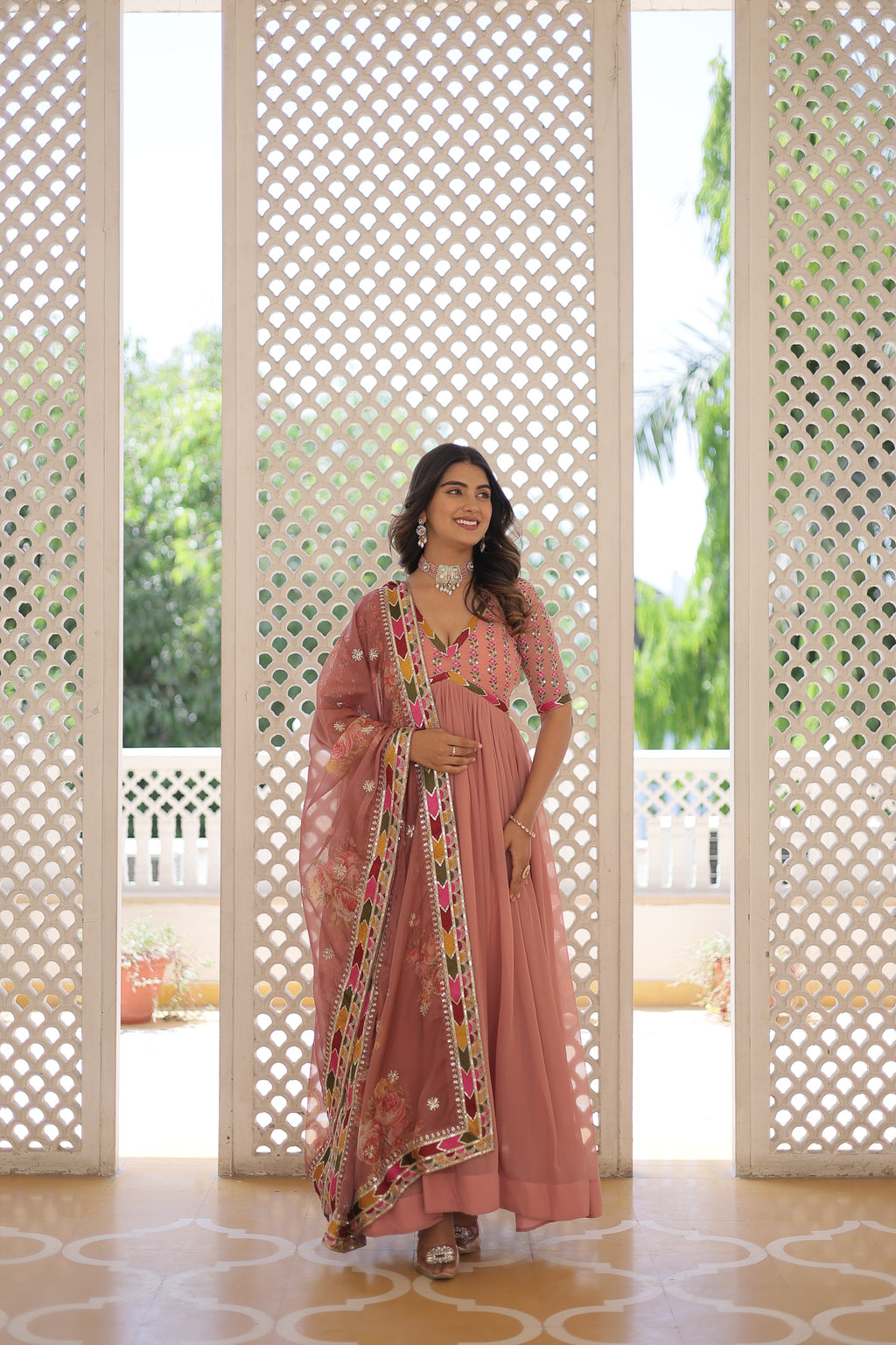 Model wearing a peach Alia Cut gown with a matching dupatta
