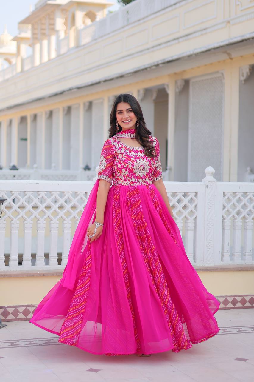 Vibrant pink Bandhej festival gown with traditional tie-dye patterns, paired with a matching dupatta.