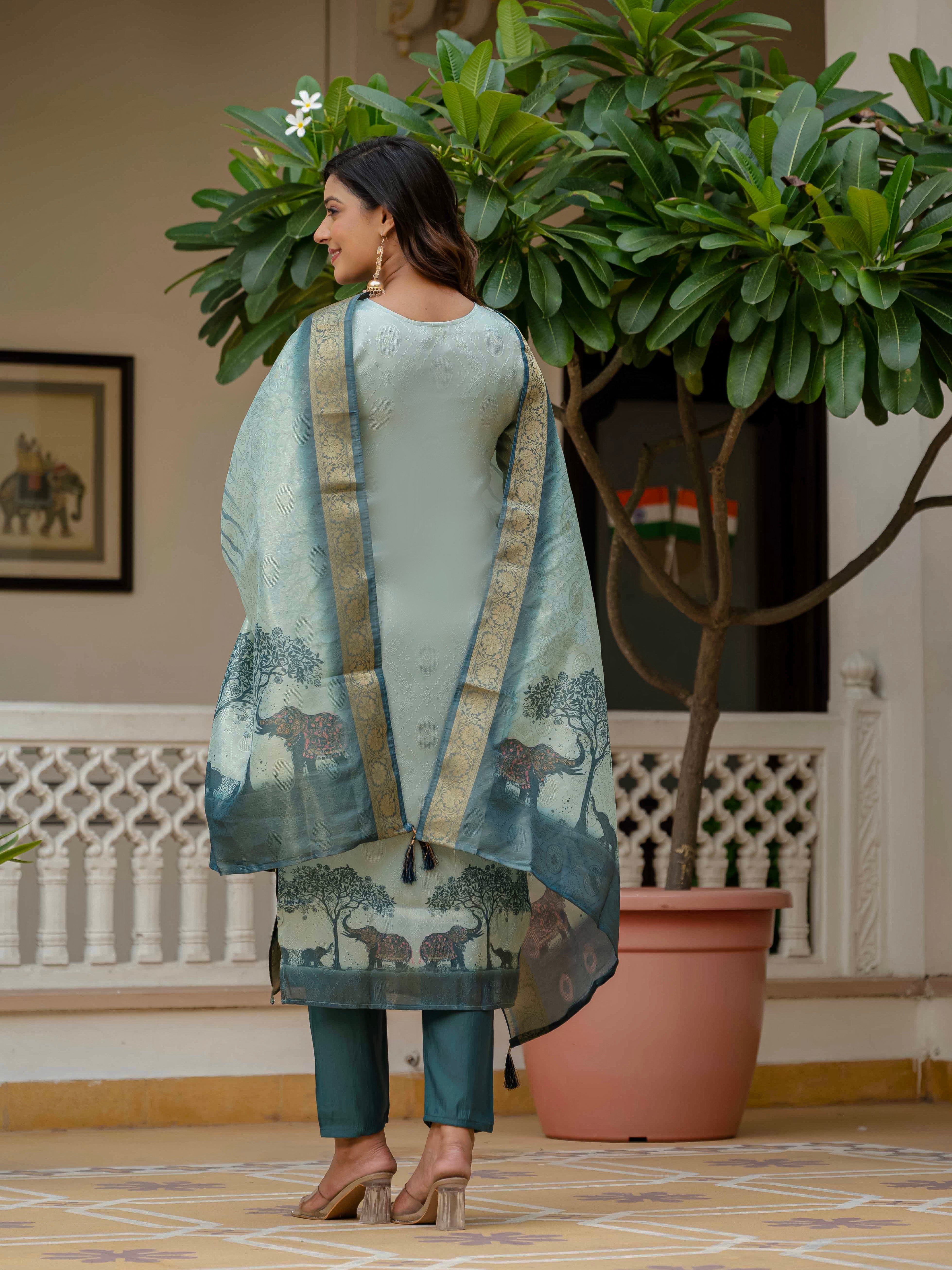 Full back view of a woman showcasing the Royal Blue kurta set with matching dupatta, standing by a plant.