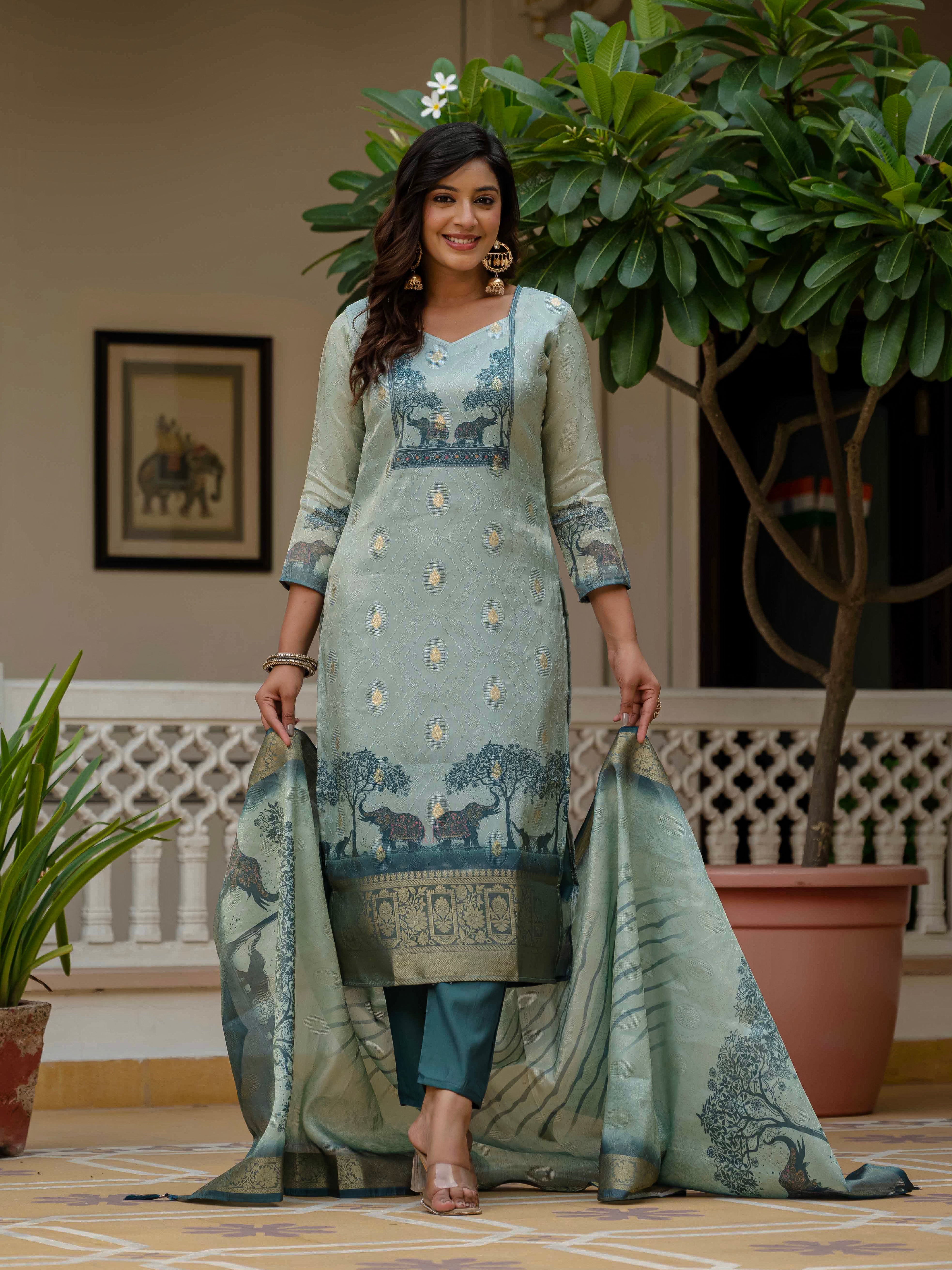 Woman holding out the Royal Blue jacquard silk dupatta, showcasing its full design and print.