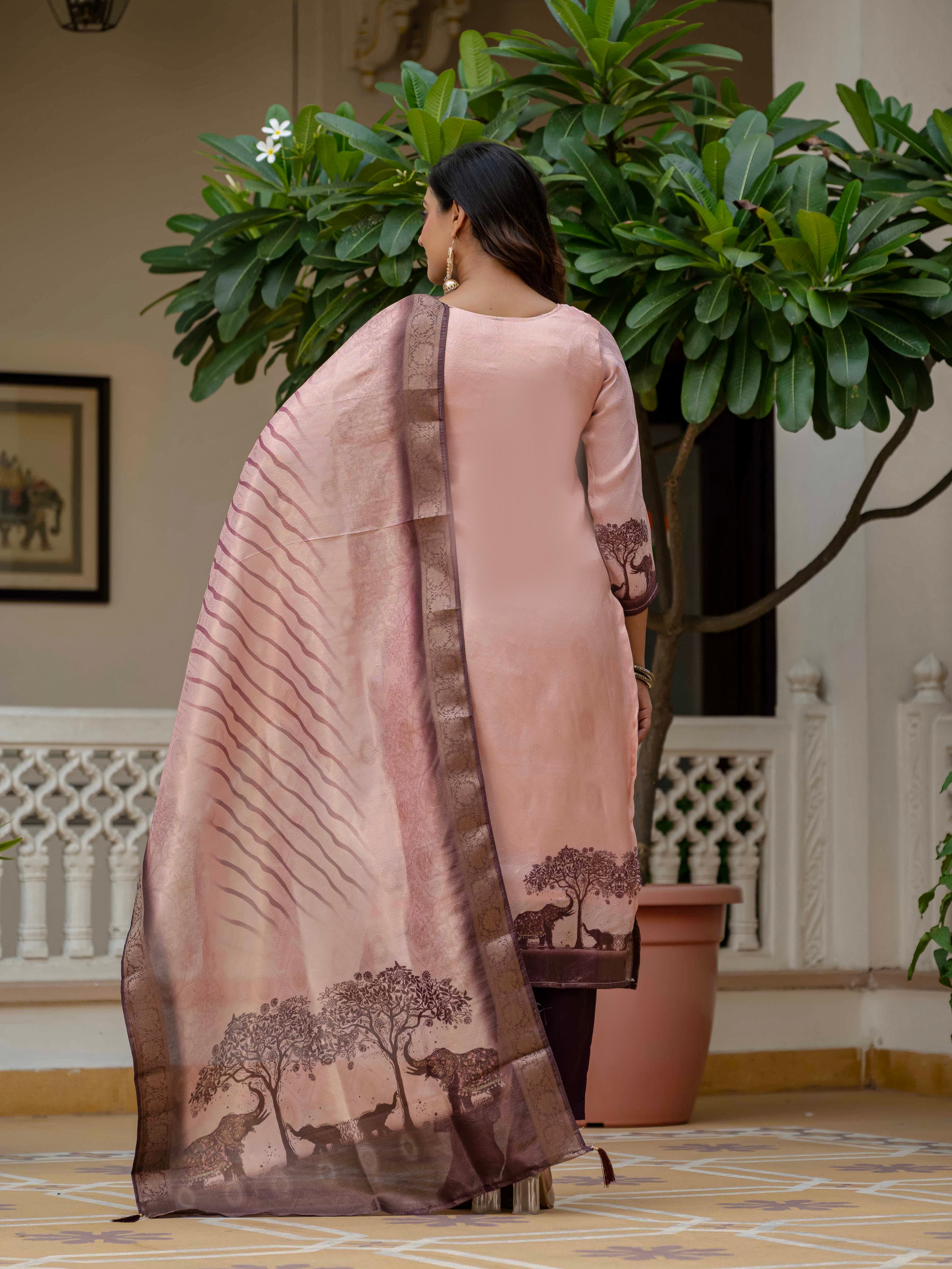 Full back view of a woman showcasing the Royal Pink kurta set with matching dupatta, standing by a plant.
