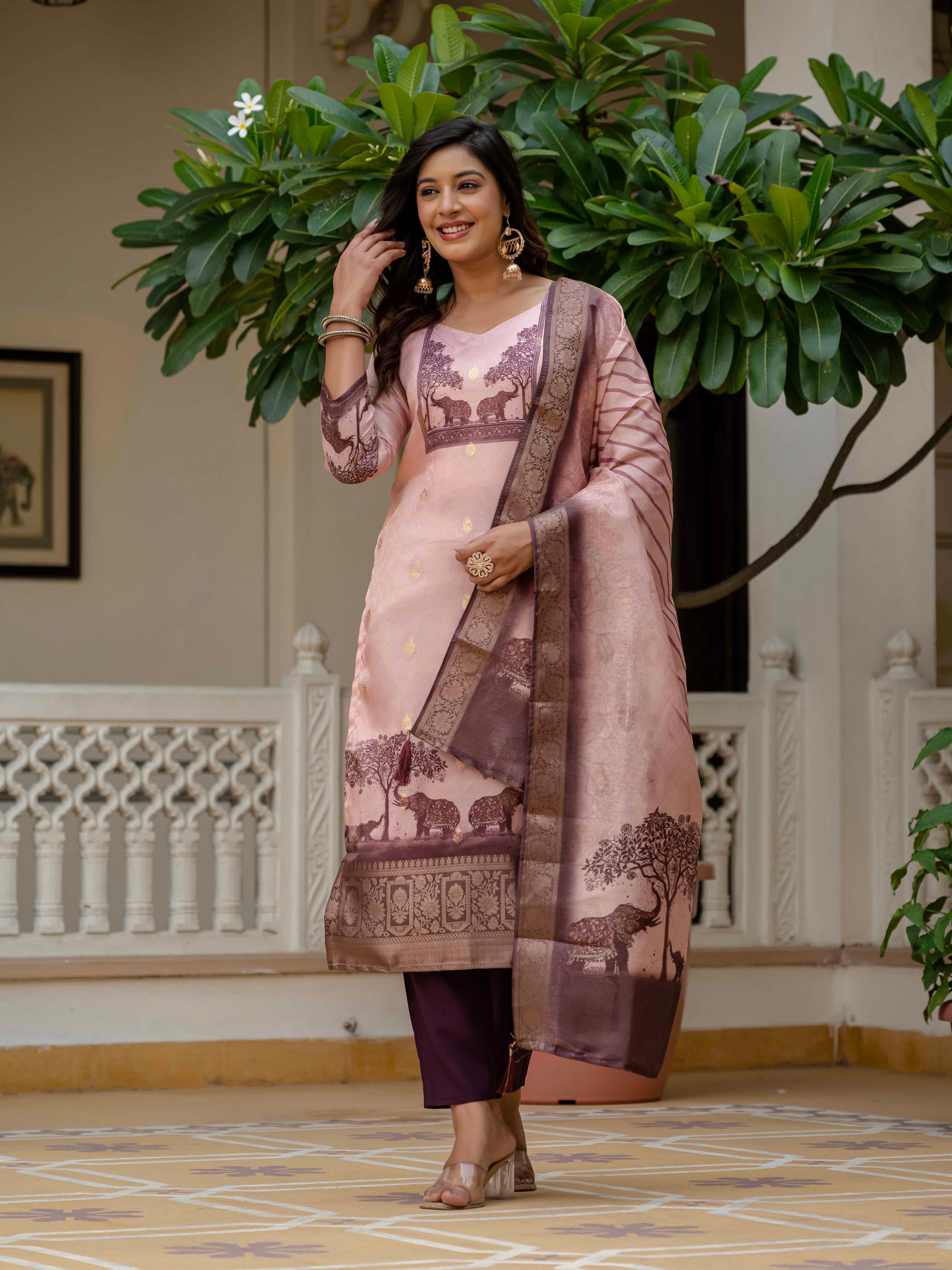 Woman in Royal Pink jacquard silk kurta set smiling and looking away, showcasing style.