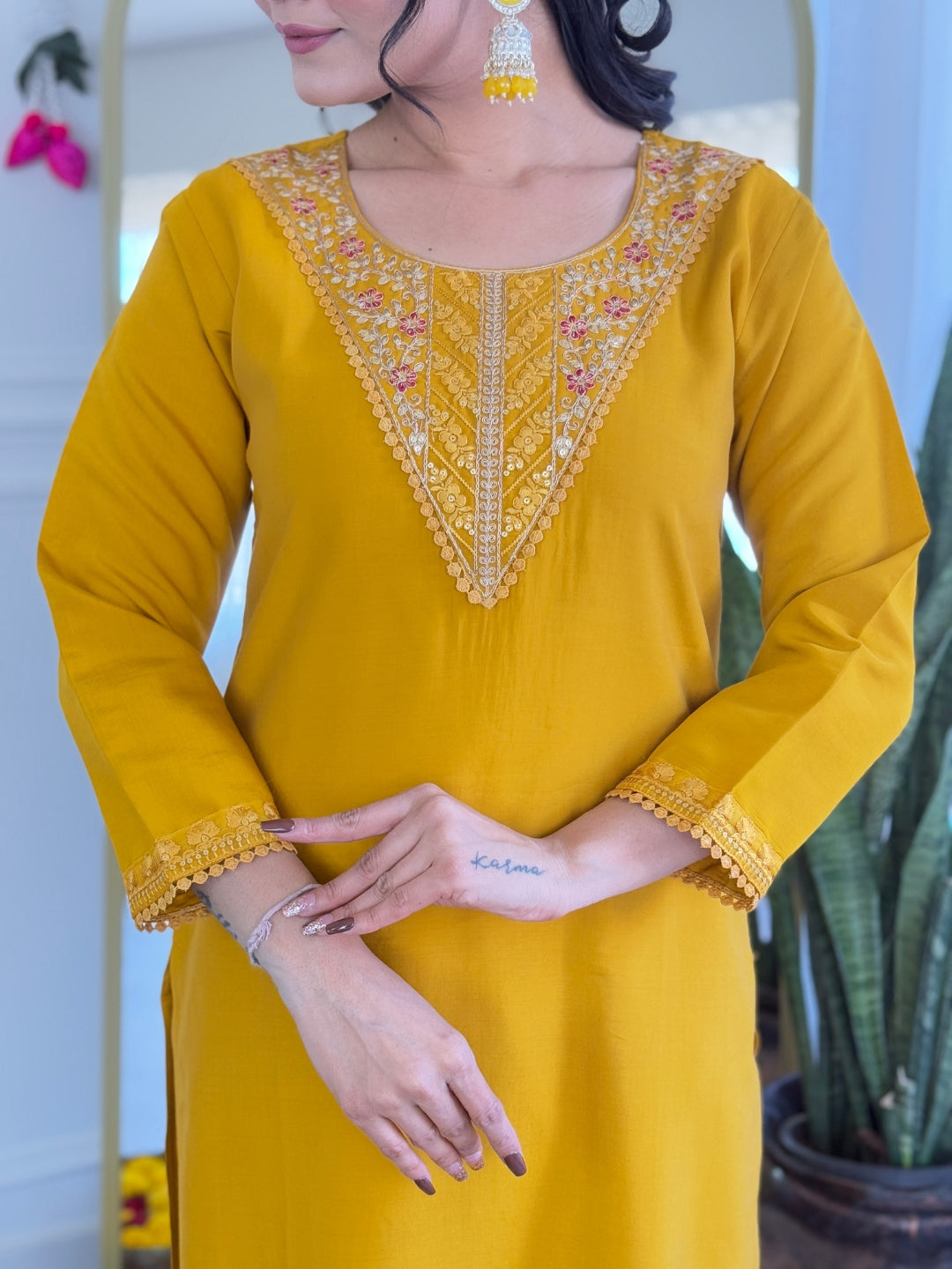 Close-up of the elegant embroidered neckline and sleeve details of the TRENDBUY VI-Rose Mustard Yellow Chanderi Silk Kurti, highlighting the intricate floral work.