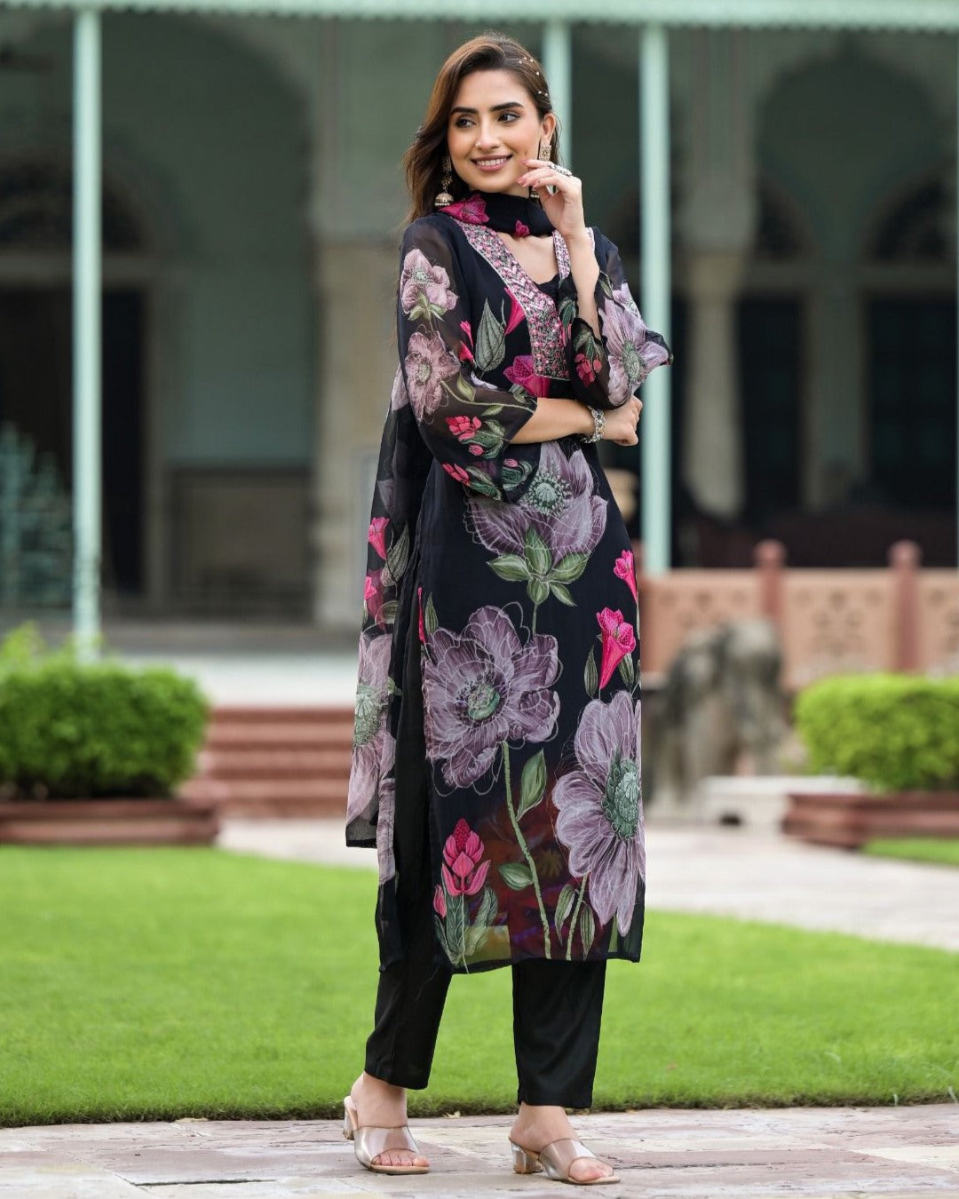 Smiling woman in TRENDBUY Sonika black Georgette kurta set, showcasing its comfortable and stylish fit.