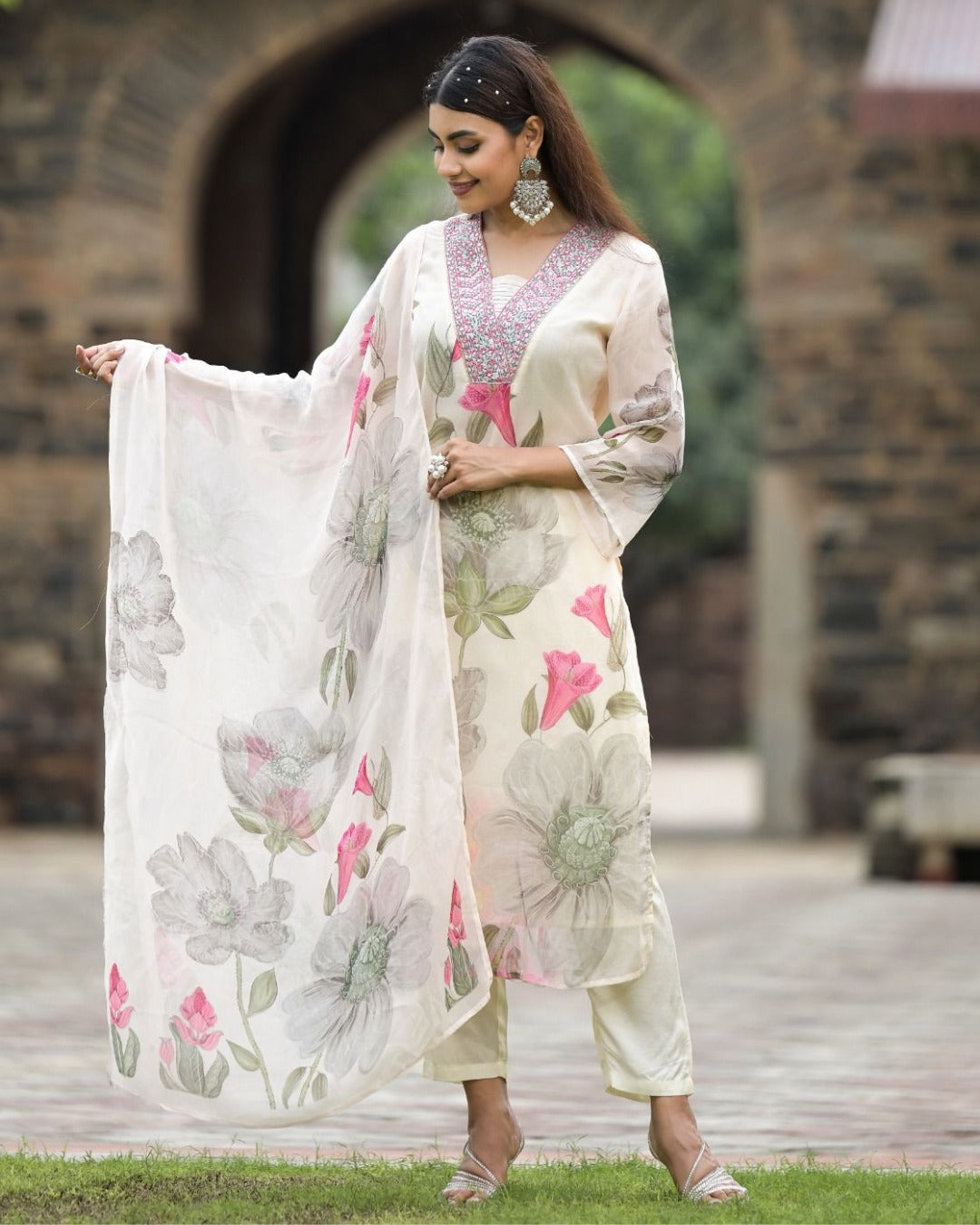 TRENDBUY Sonika white Georgette kurta set with pink floral print and embroidered neckline, model posing outdoors.